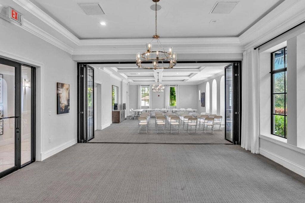12143 S Baypoint Circle, Parkland, FL 33076 Spacious interior room featuring carpeted flooring and a multi-pane glass folding door system