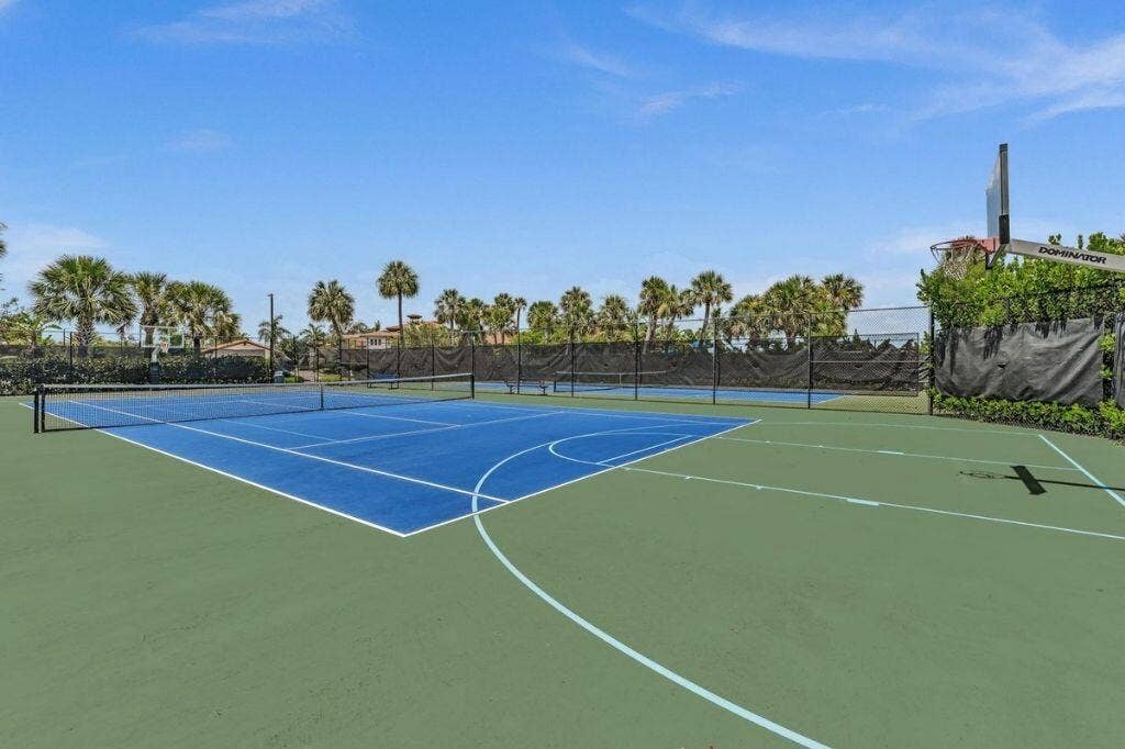 12143 S Baypoint Circle, Parkland, FL 33076 Multi-sport court featuring a blue tennis court and green surrounding surface
