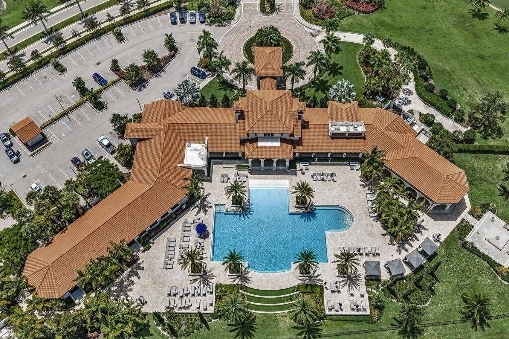 12143 S Baypoint Circle, Parkland, FL 33076 Expansive multi-building complex featuring a large, irregularly shaped swimming pool with integrated spa