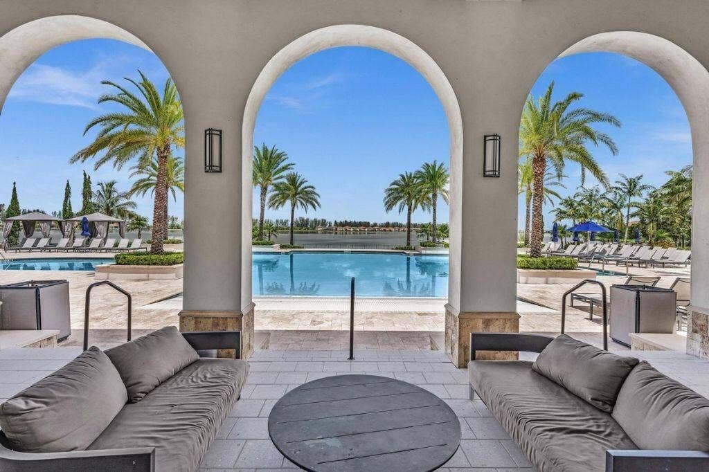 12143 S Baypoint Circle, Parkland, FL 33076 Archway patio featuring an outdoor seating area with direct access to a swimming pool