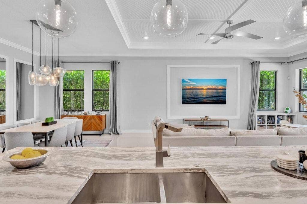 12143 S Baypoint Circle, Parkland, FL 33076 Kitchen island with a stainless steel sink and a modern faucet