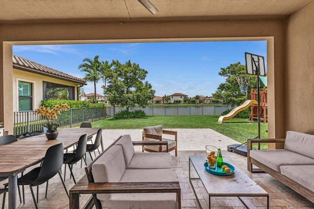 12143 S Baypoint Circle, Parkland, FL 33076 Covered outdoor patio with a ceiling fan, featuring a tile floor and substantial open space