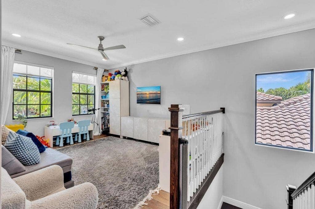 12143 S Baypoint Circle, Parkland, FL 33076 Spacious landing featuring a ceiling fan, recessed lighting, and wood-finish flooring