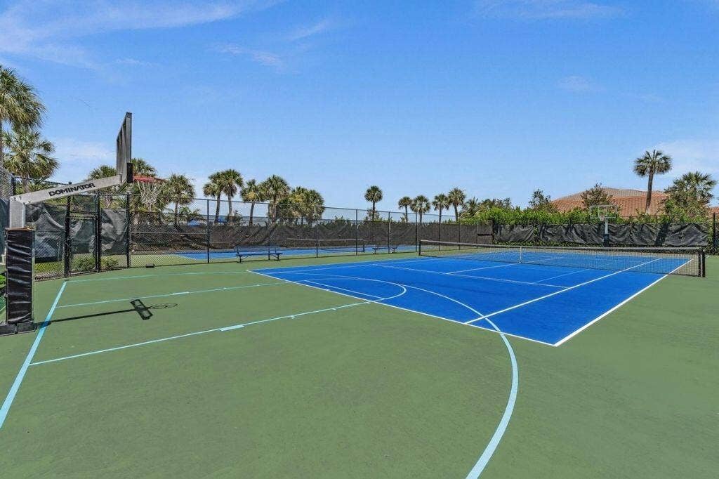 12143 S Baypoint Circle, Parkland, FL 33076 Multi-sport court featuring a blue tennis surface and green basketball court with clear line markings