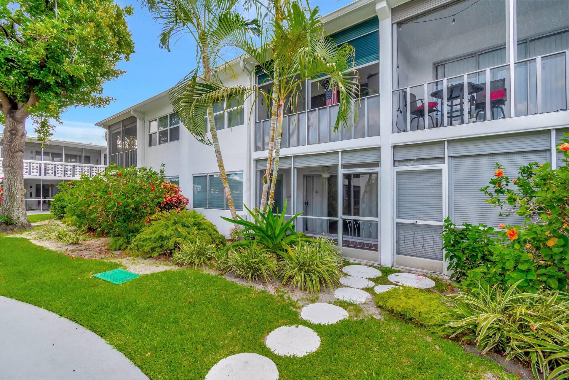 2161 NE 42nd Court, #116, Lighthouse Point, FL 33064 Manicured landscaping with mature trees and tropical plantings