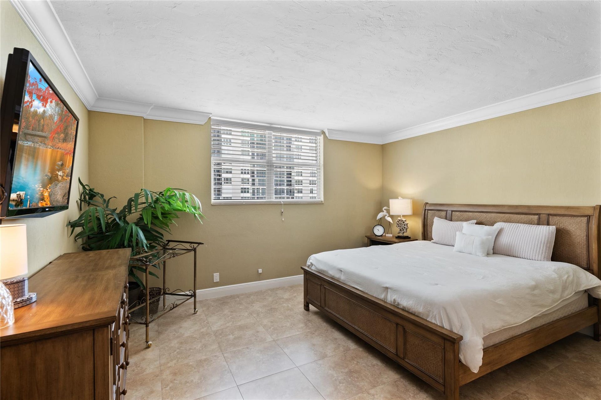 4250 GALT OCEAN Drive, #8L, Fort Lauderdale, Fort Lauderdale, FL 33308 Recessed window with blinds, crown molding, wall-mounted television, and tile flooring