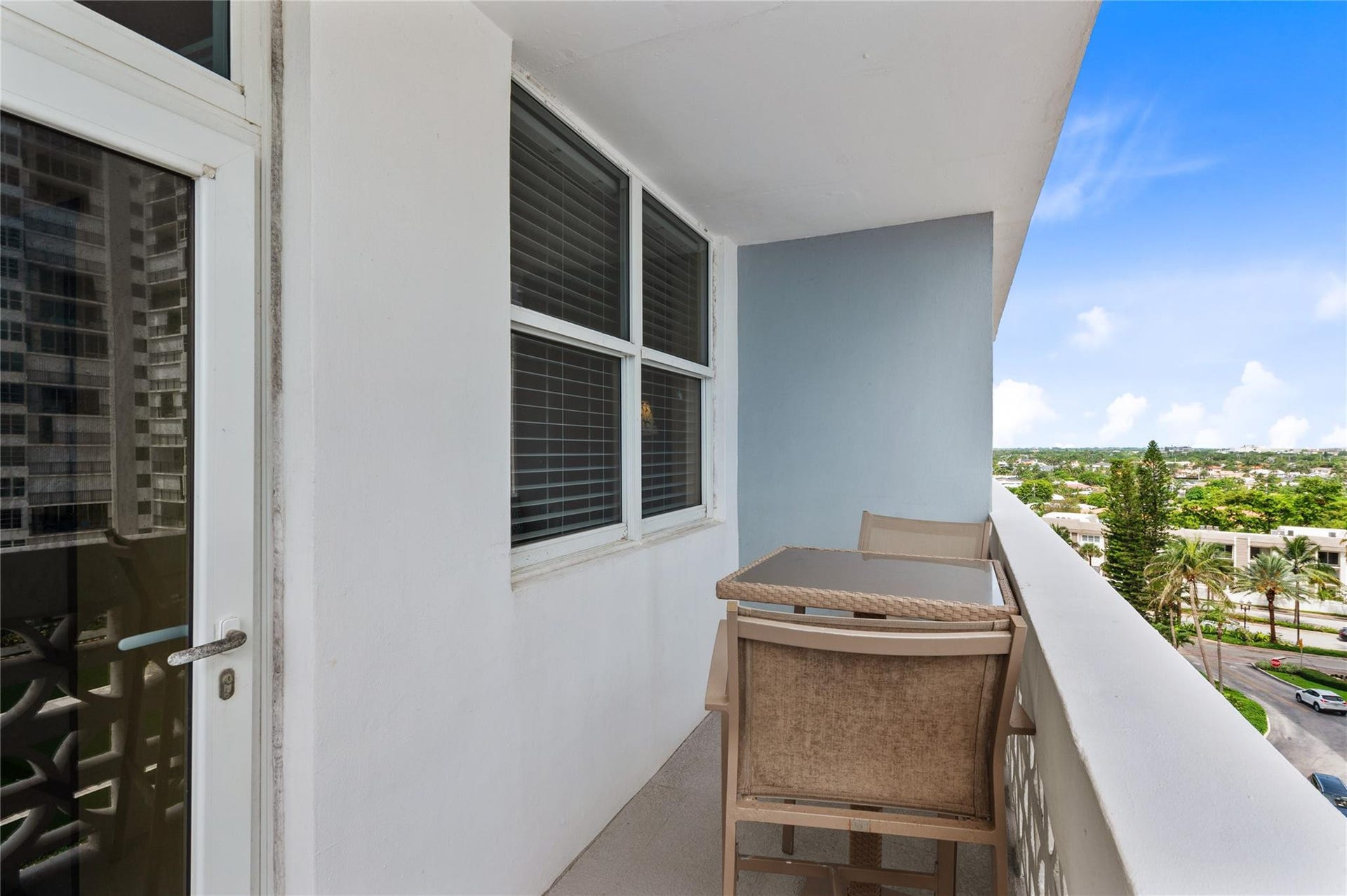 4250 GALT OCEAN Drive, #8L, Fort Lauderdale, Fort Lauderdale, FL 33308 Balcony with partial glass entry door, white painted walls, and a patterned white railing