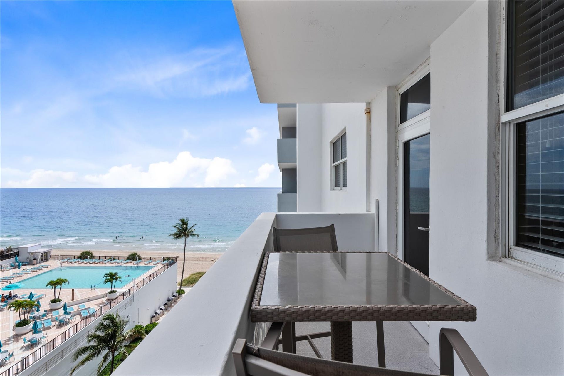 4250 GALT OCEAN Drive, #8L, Fort Lauderdale, Fort Lauderdale, FL 33308 Private balcony with white railings, offering an oceanfront setting, and overlooking a resort-style pool