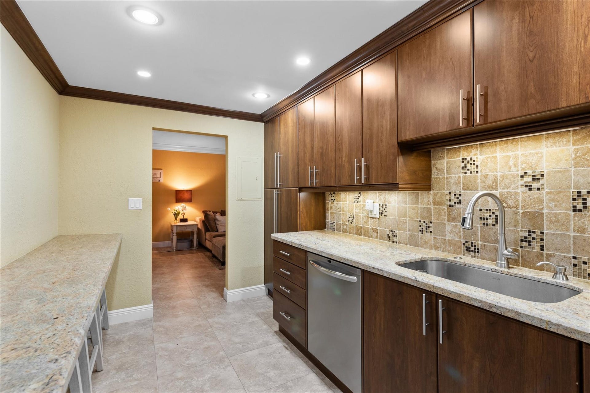 4250 GALT OCEAN Drive, #8L, Fort Lauderdale, Fort Lauderdale, FL 33308 Kitchen featuring wood-finish cabinetry, granite countertops, a stainless steel sink, a tile backsplash with mosaic accents, and recessed lighting