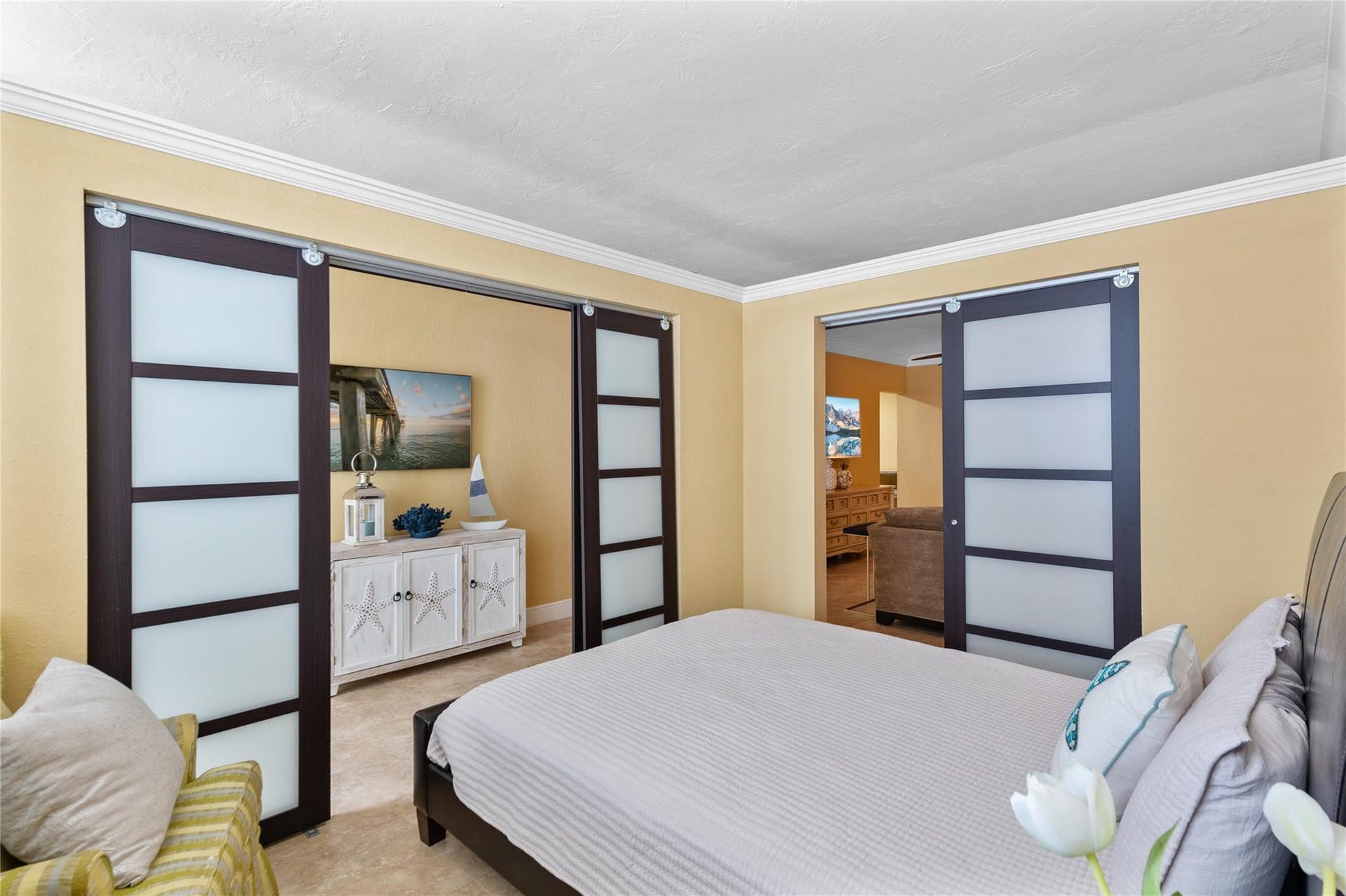 4250 GALT OCEAN Drive, #8L, Fort Lauderdale, Fort Lauderdale, FL 33308 Smooth-gliding barn doors with frosted glass panels, crown molding, and tiled flooring
