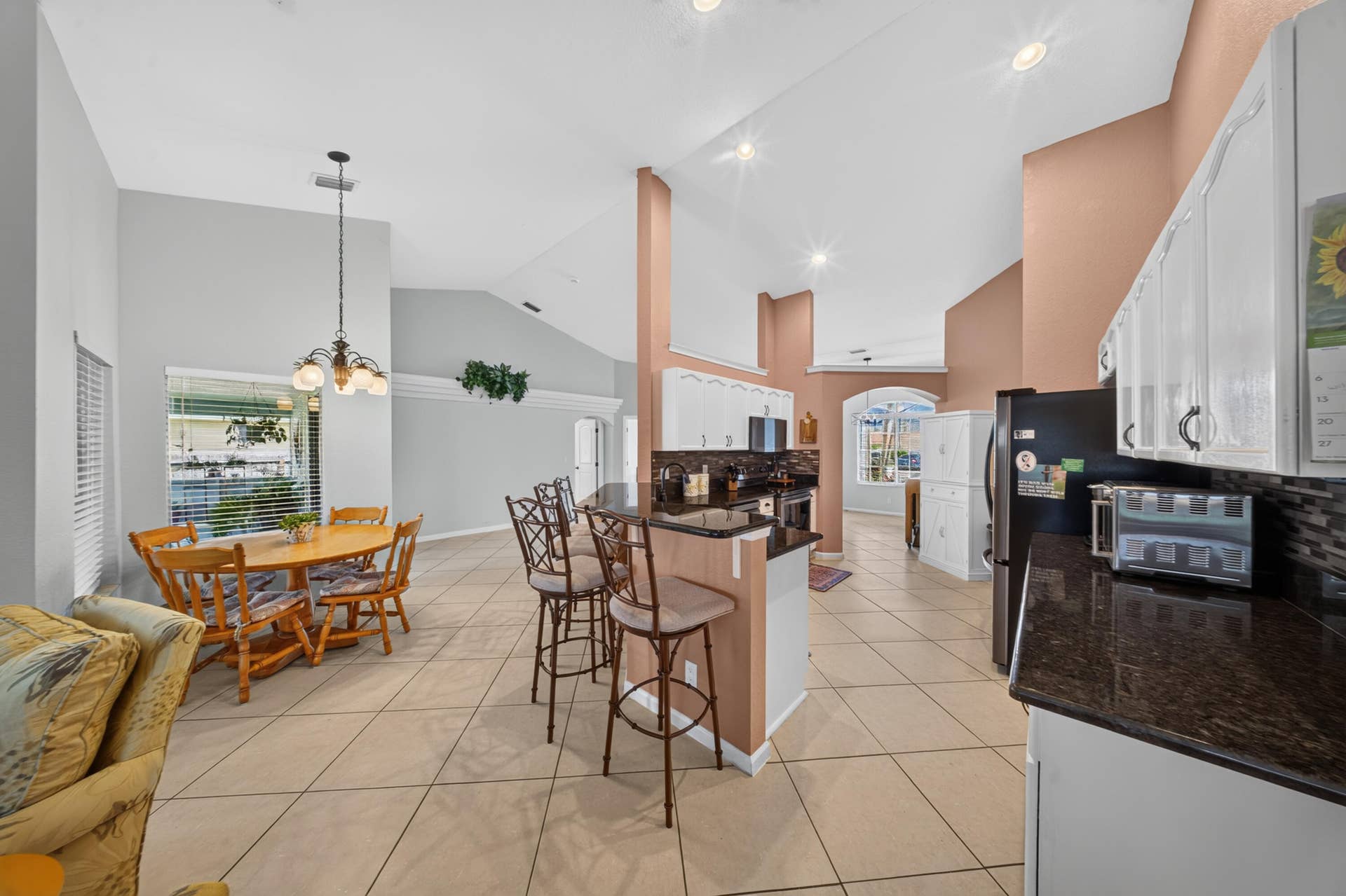 3274 SW CRUMPACKER Street, Port St Lucie, FL 34953 Vaulted ceilings complement the tile flooring throughout this kitchen and dining area