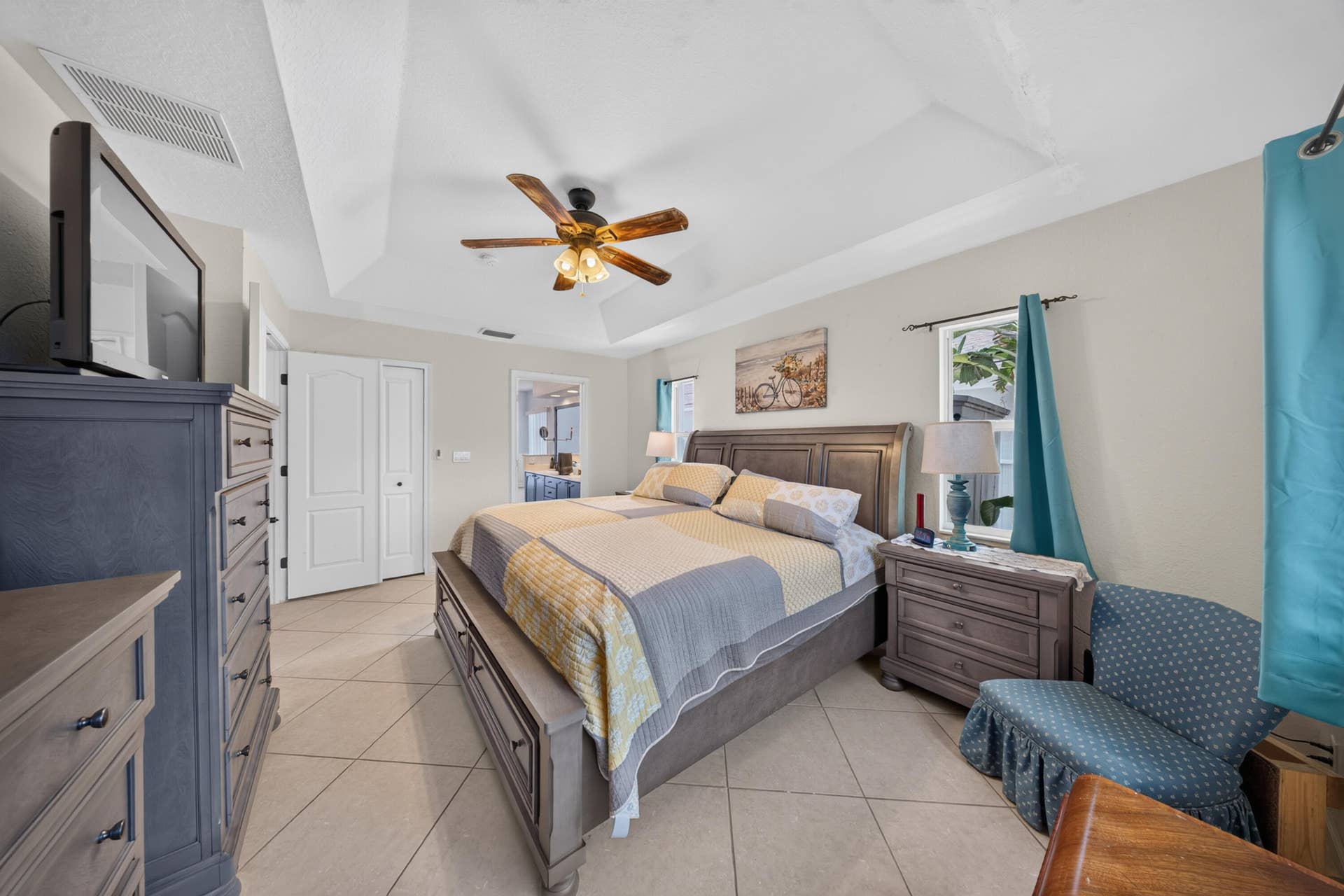3274 SW CRUMPACKER Street, Port St Lucie, FL 34953 Recessed tray ceiling with a built-in ceiling fan, white paneled doors, and large format tile flooring