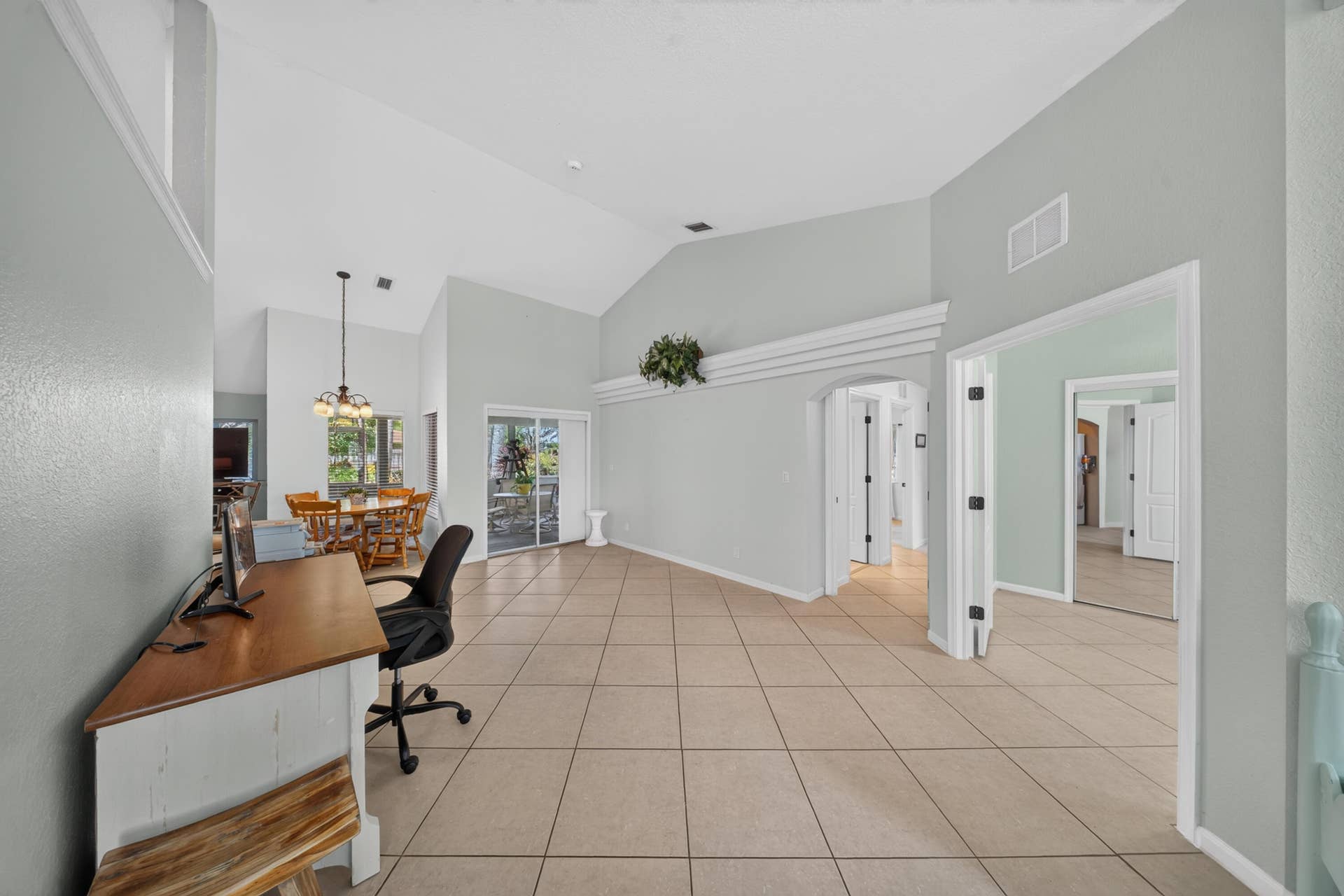 3274 SW CRUMPACKER Street, Port St Lucie, FL 34953 Vaulted ceilings enhance the expansive tile flooring throughout