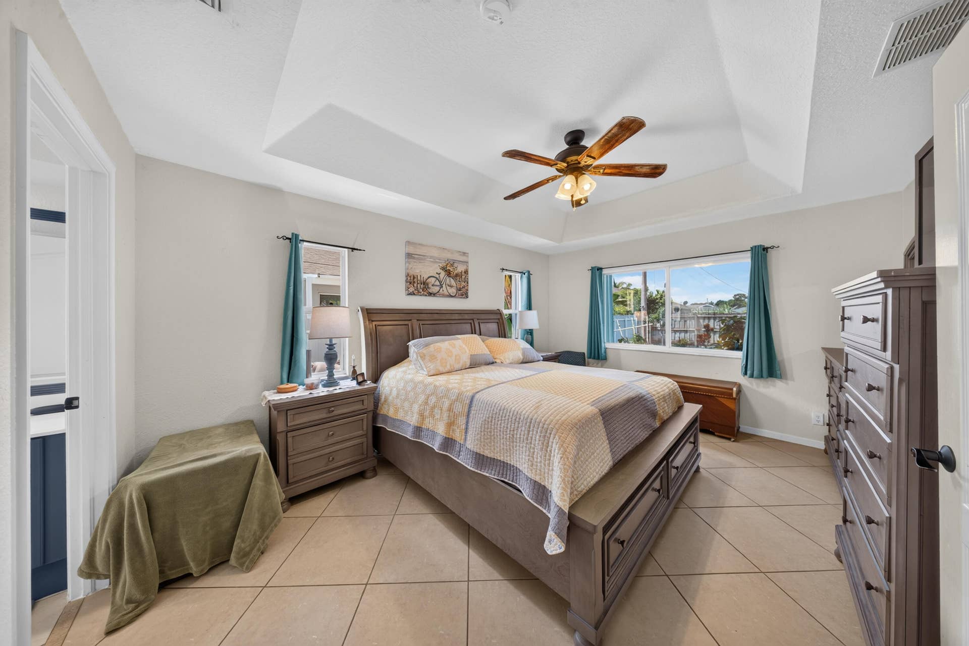 3274 SW CRUMPACKER Street, Port St Lucie, FL 34953 Tray ceiling with a ceiling fan, recessed lighting, tile flooring, and large windows