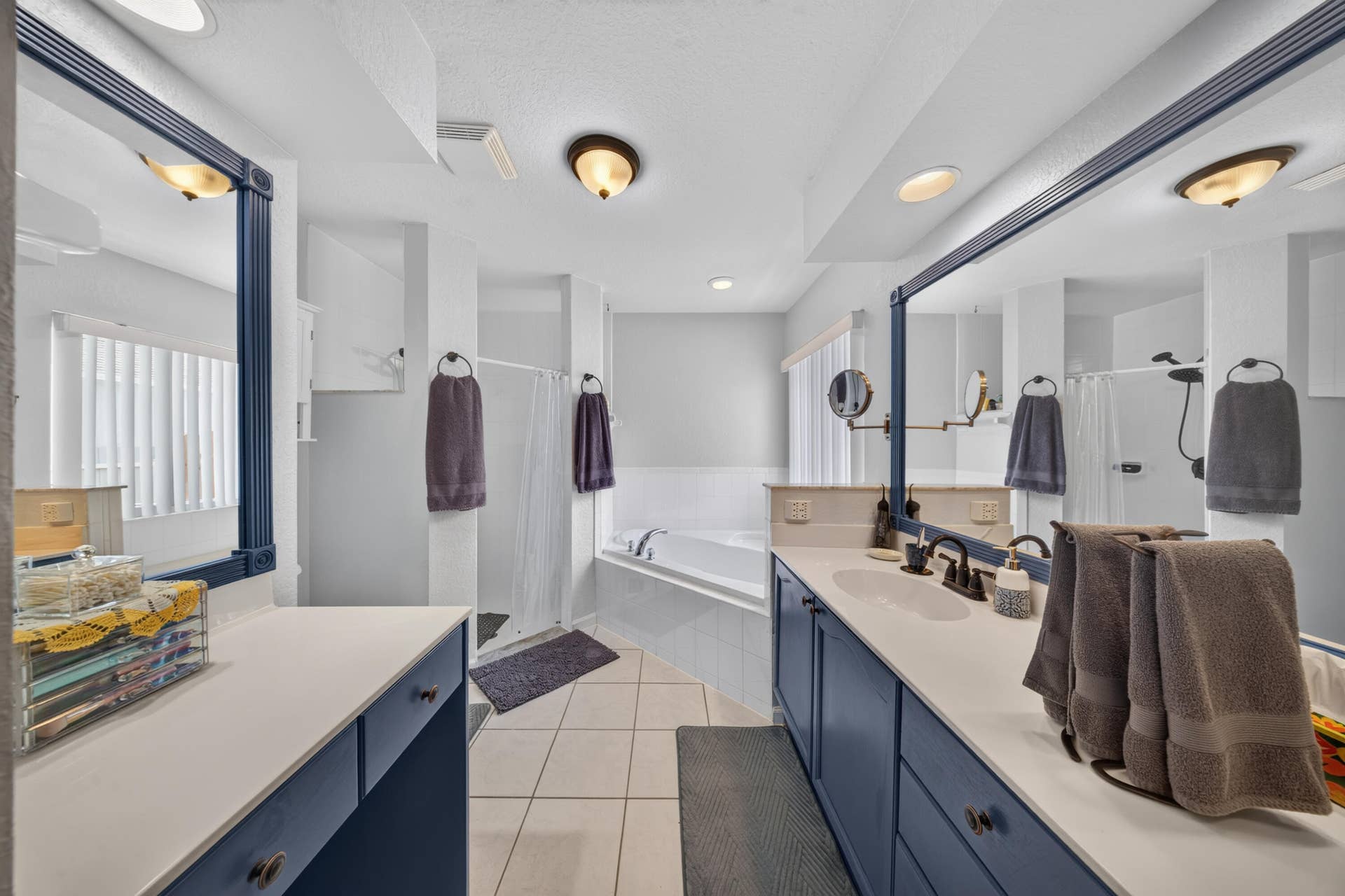 3274 SW CRUMPACKER Street, Port St Lucie, FL 34953 Dual vanities with integrated sinks, a built-in bathtub, a walk-in shower, and tile flooring