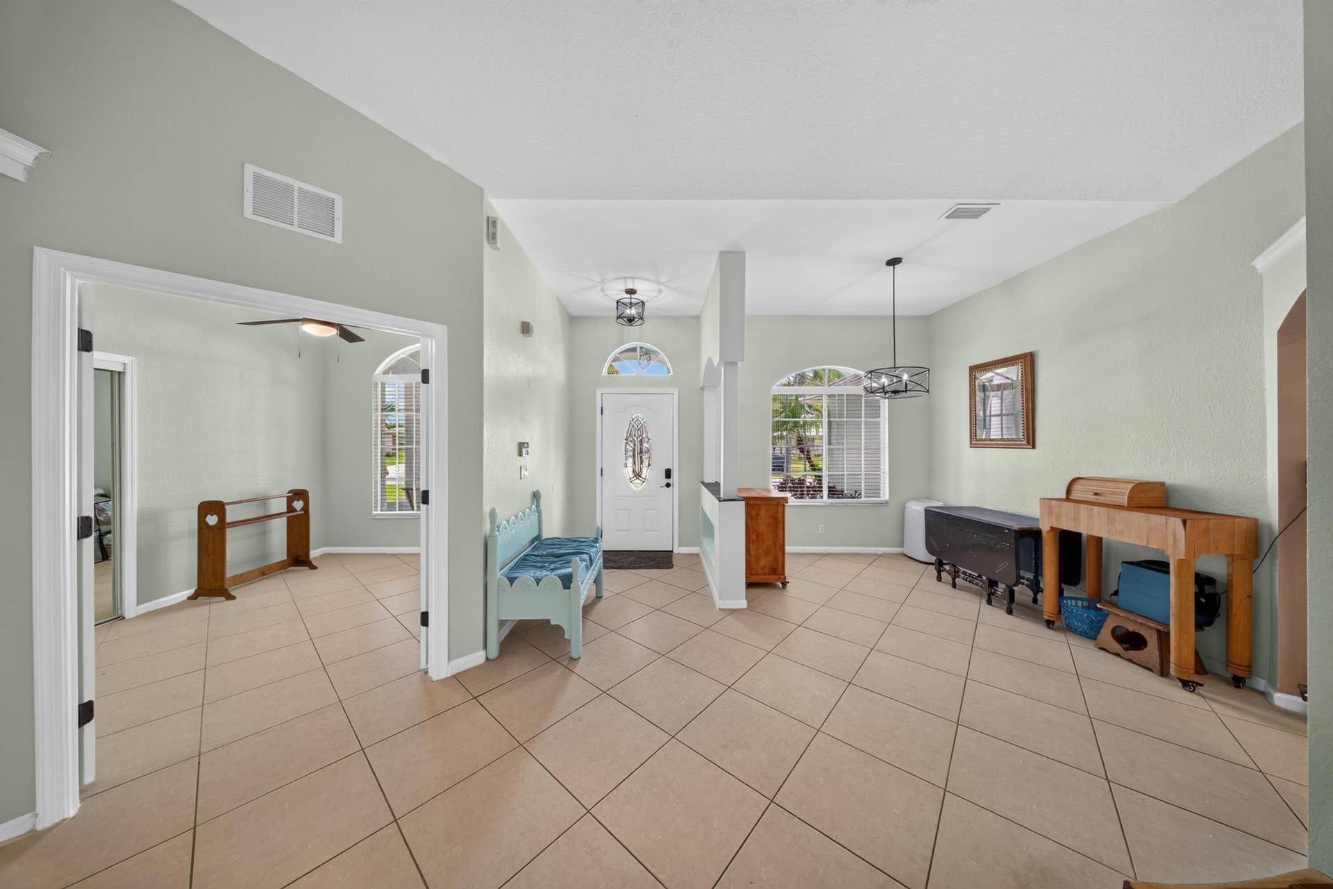 3274 SW CRUMPACKER Street, Port St Lucie, FL 34953 Vaulted ceilings, tile flooring, arched windows, transom window above the entrance, and recessed lighting