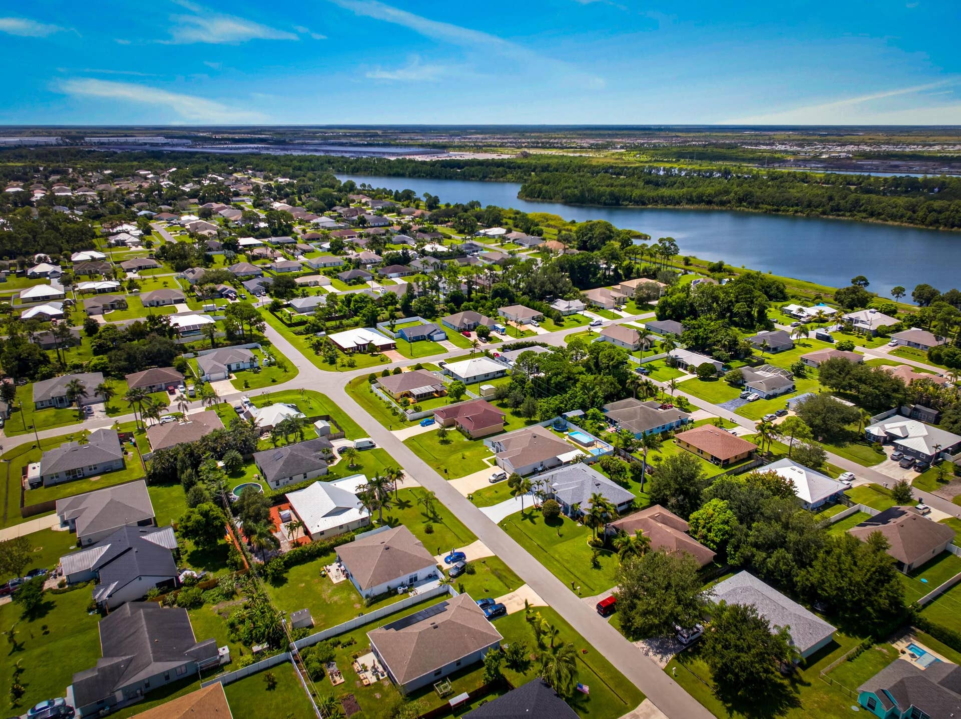 3274 SW CRUMPACKER Street, Port St Lucie, FL 34953 Residential community featuring single-story homes, mature landscaping, and paved streets