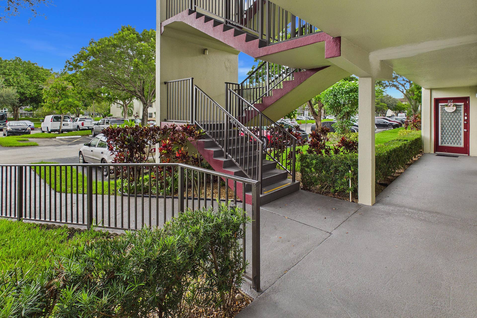 13155 SW 7TH Court, #103E, Pembroke Pines, FL 33027 Exterior staircase with metal railings, a covered walkway.
