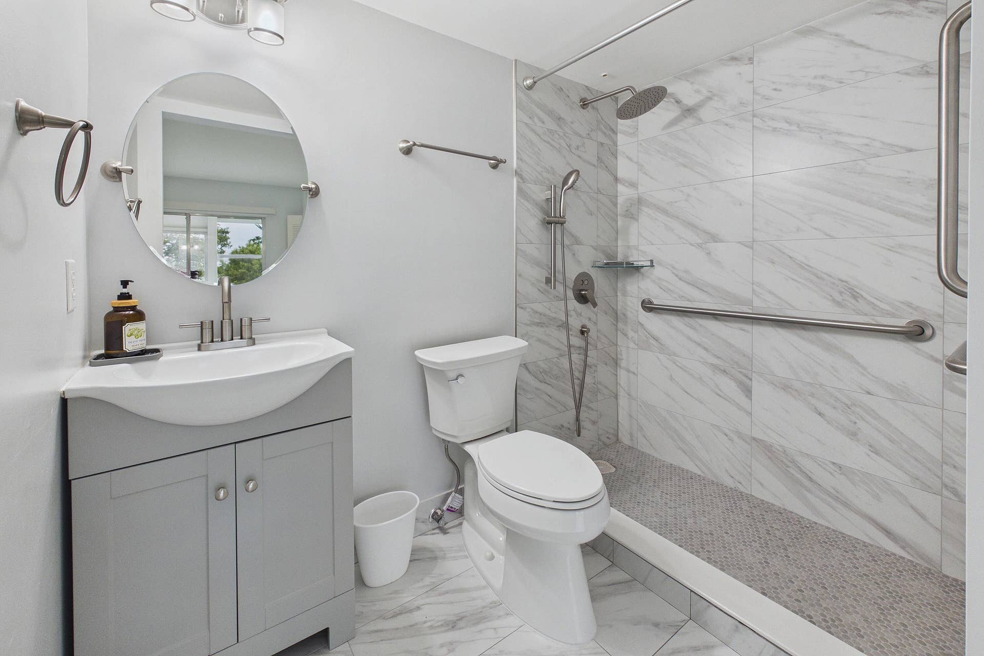 13155 SW 7TH Court, #103E, Pembroke Pines, FL 33027 Renovated handicap accessible walk-in shower, vanity with integrated sink and cabinet storage