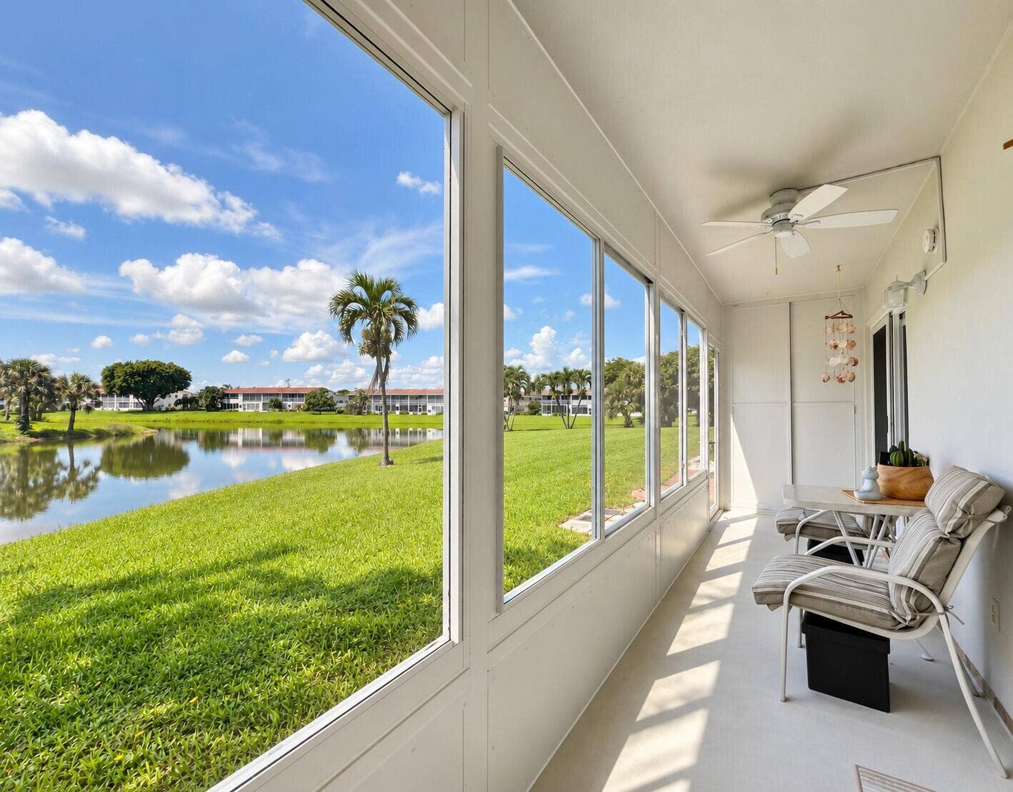 108 SOMERSET F, West Palm Beach, FL 33417 Long Lanai With Updated Impact Windows, Door to Exterior, and Storage Closet