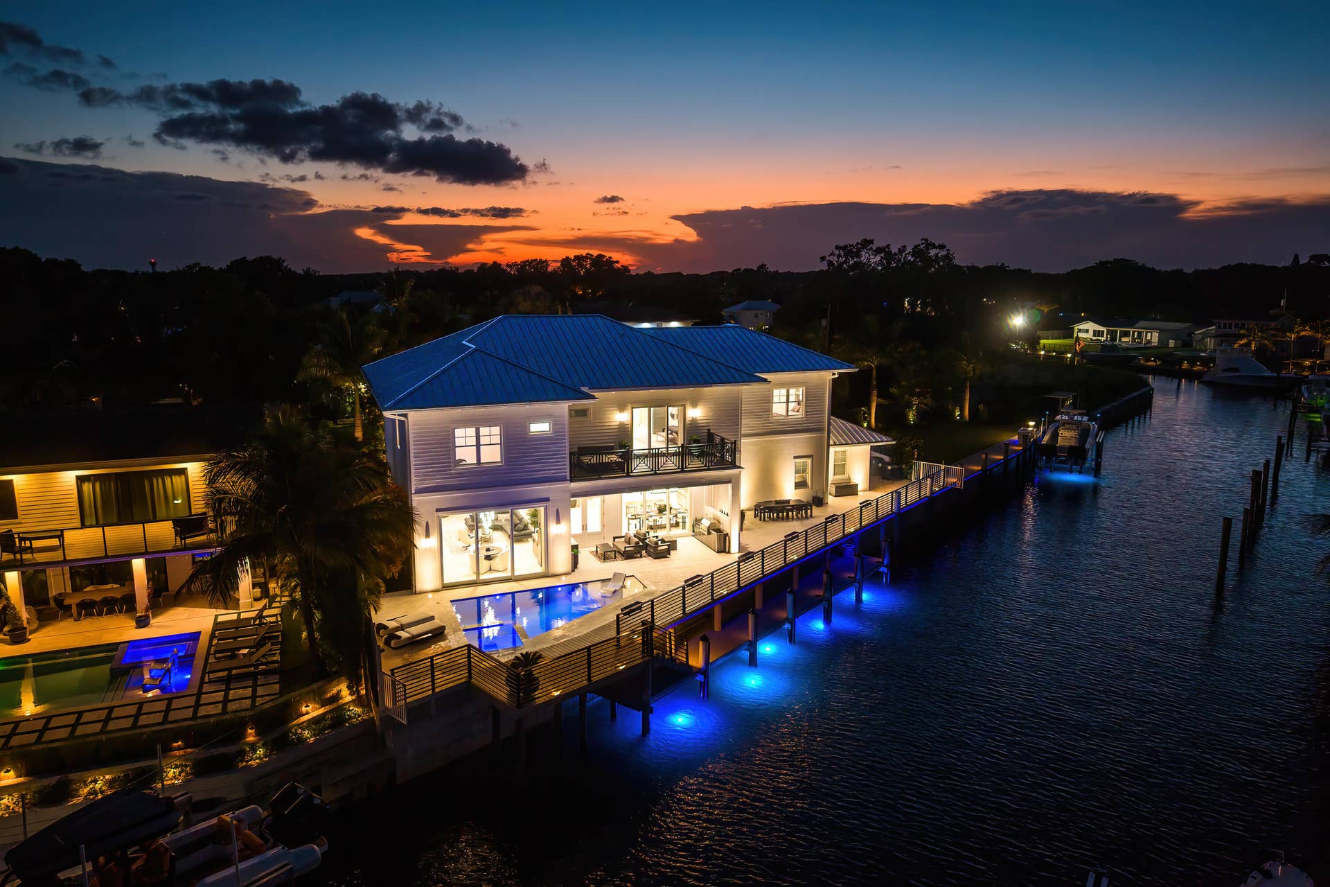 12898 S Shore Drive, Palm Beach Gardens, FL 33410 Night View of the Property with under-dock lighting