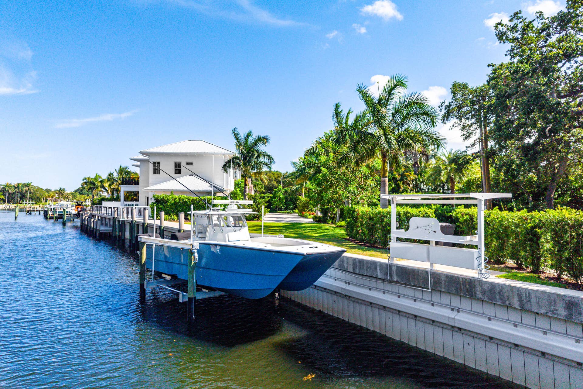 12898 S Shore Drive, Palm Beach Gardens, FL 33410 Private boat dock, boat lift, manicured landscaping and fishing station.