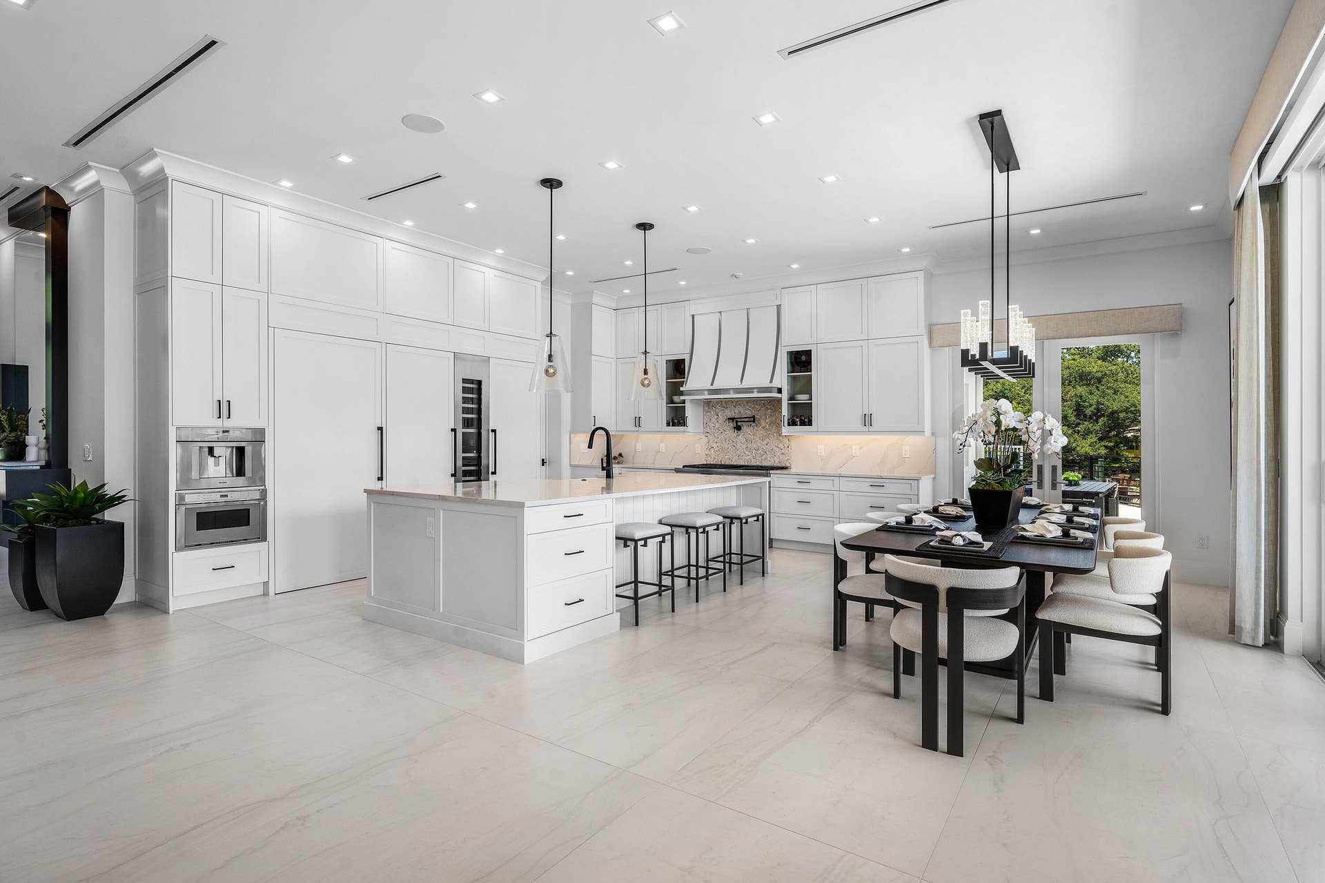 12898 S Shore Drive, Palm Beach Gardens, FL 33410 Spacious kitchen featuring white cabinetry, a large center island, and integrated appliances
