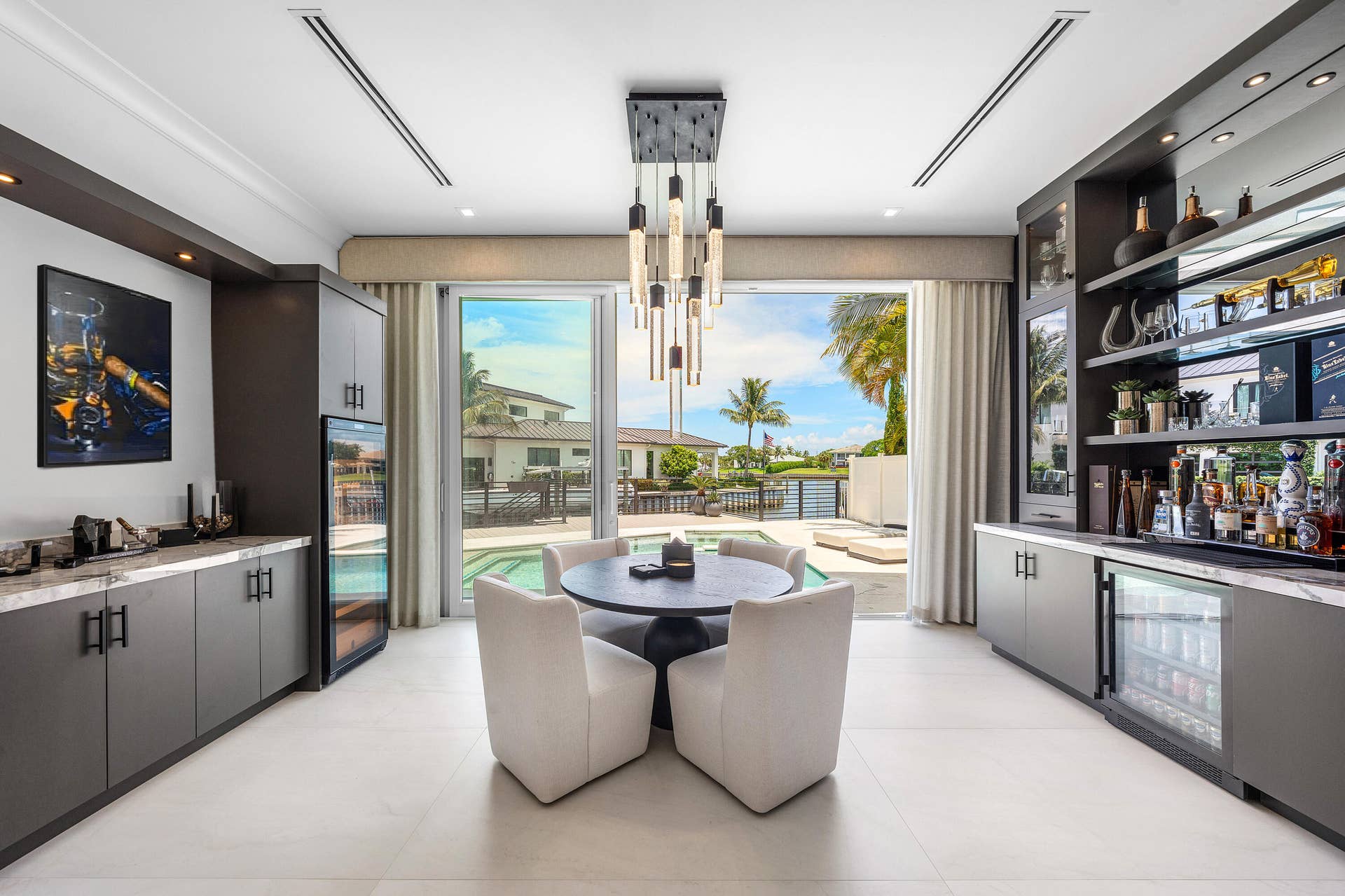 12898 S Shore Drive, Palm Beach Gardens, FL 33410 Dine with a gorgeous view of the water with easy access to your custom bar and backyard