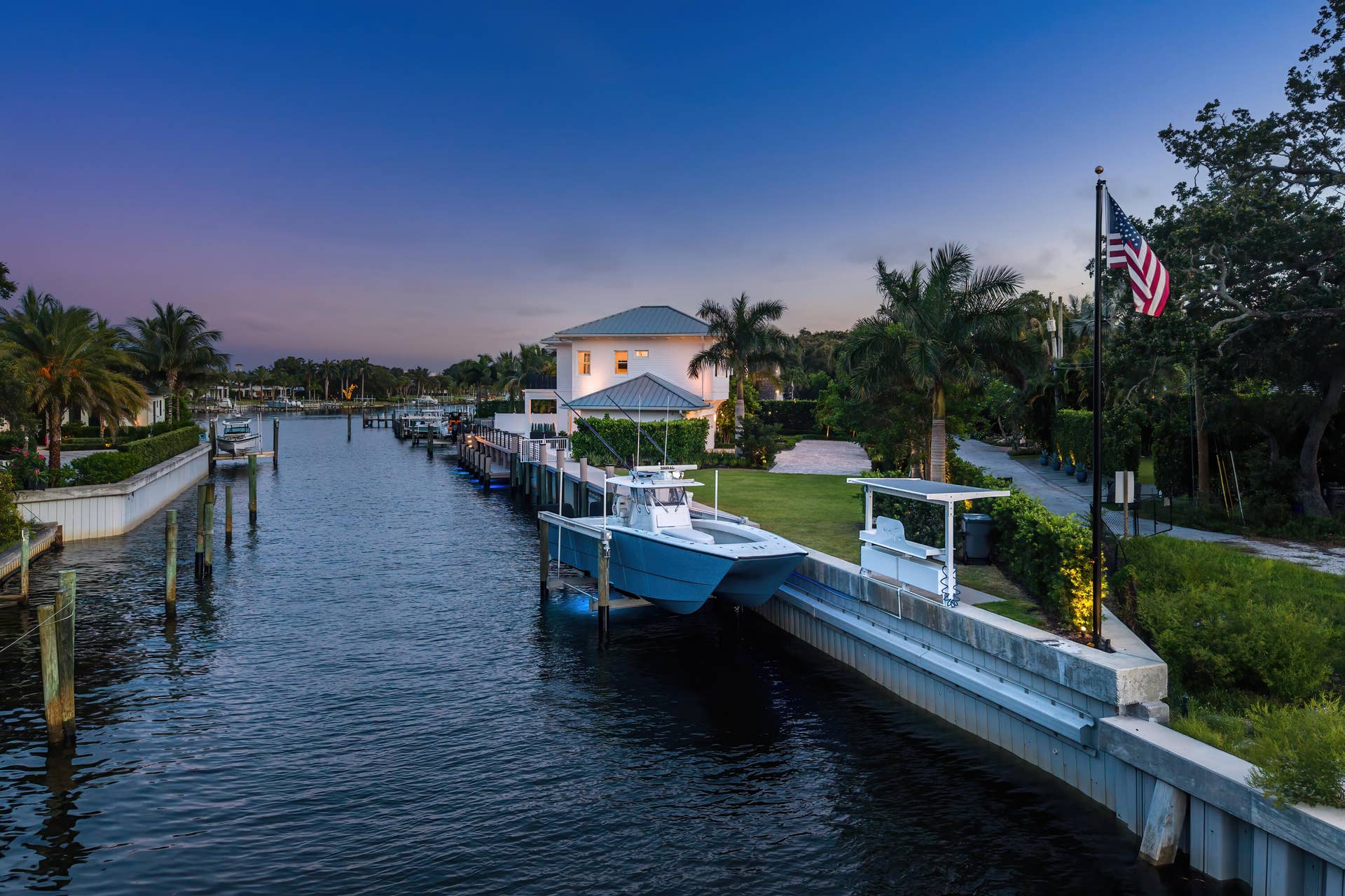 12898 S Shore Drive, Palm Beach Gardens, FL 33410 Waterfront property featuring a private boat lift, concrete seawall
