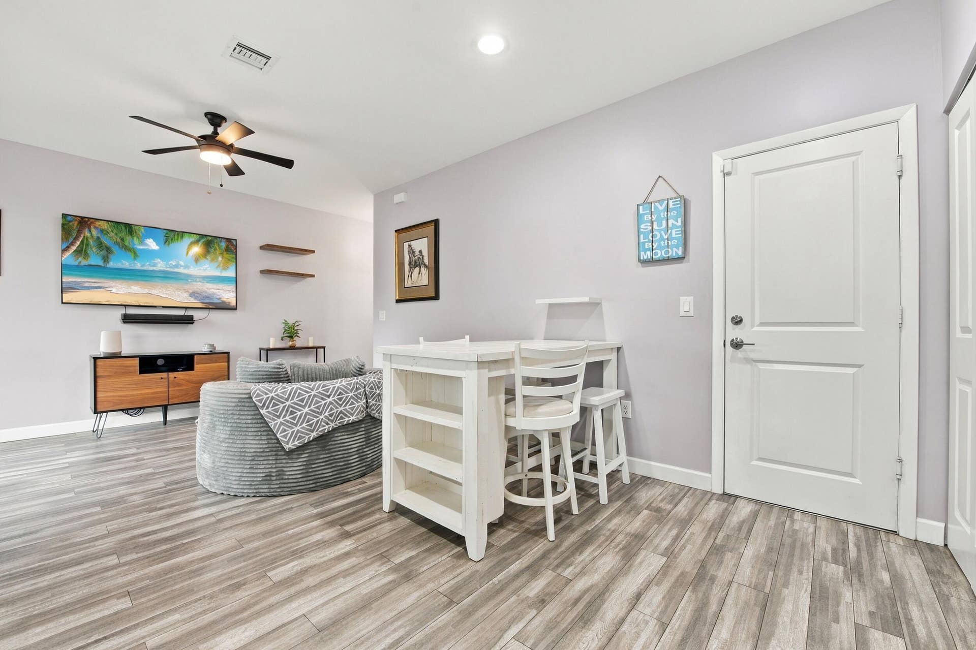 Wood-finish flooring throughout, recessed lighting, and a ceiling fan with integrated lighting