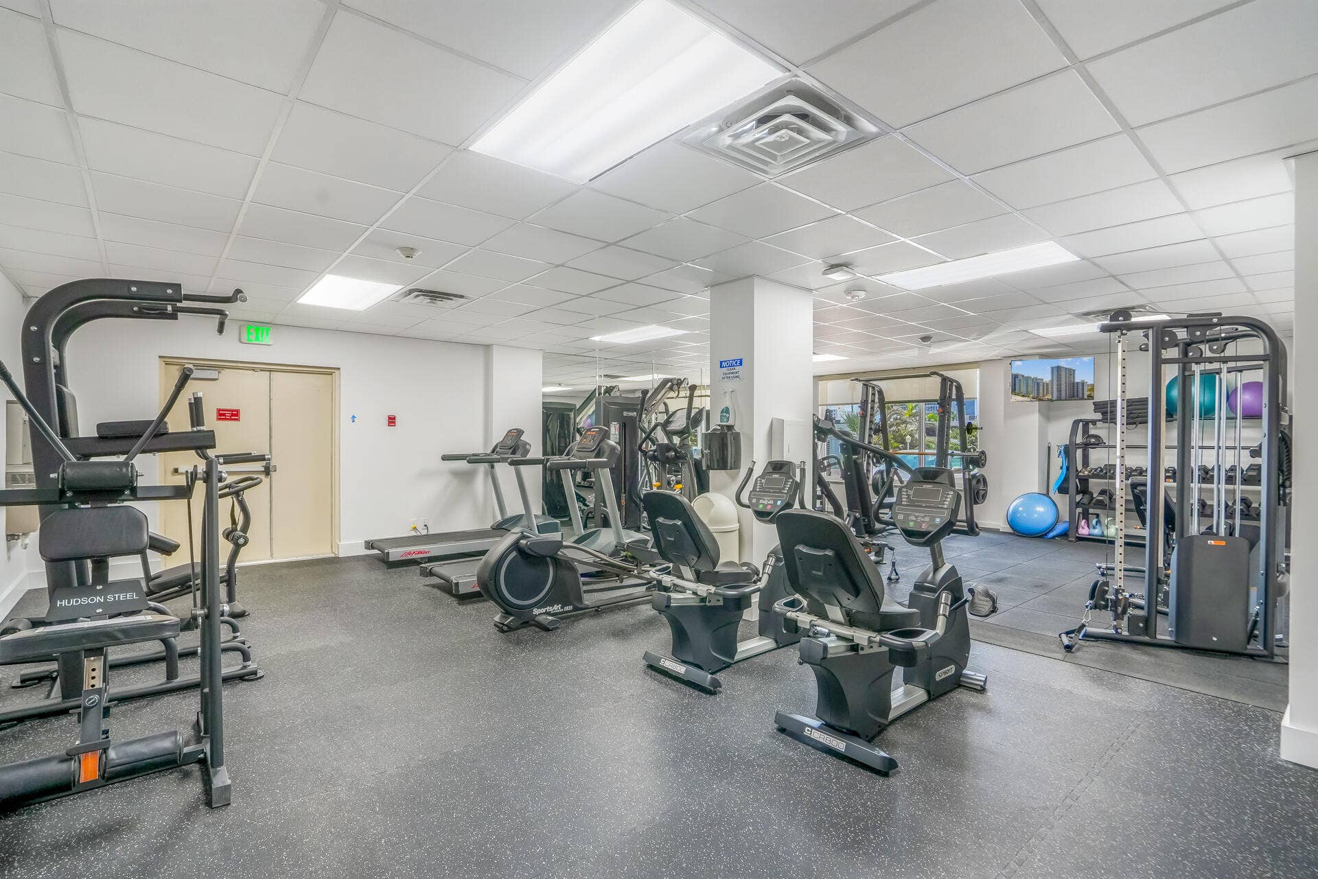 3500 Galt Ocean Drive, #807, Fort Lauderdale, FL 33308 Fitness area featuring resilient flooring, recessed lighting, mirrored walls, and a selection of exercise equipment
