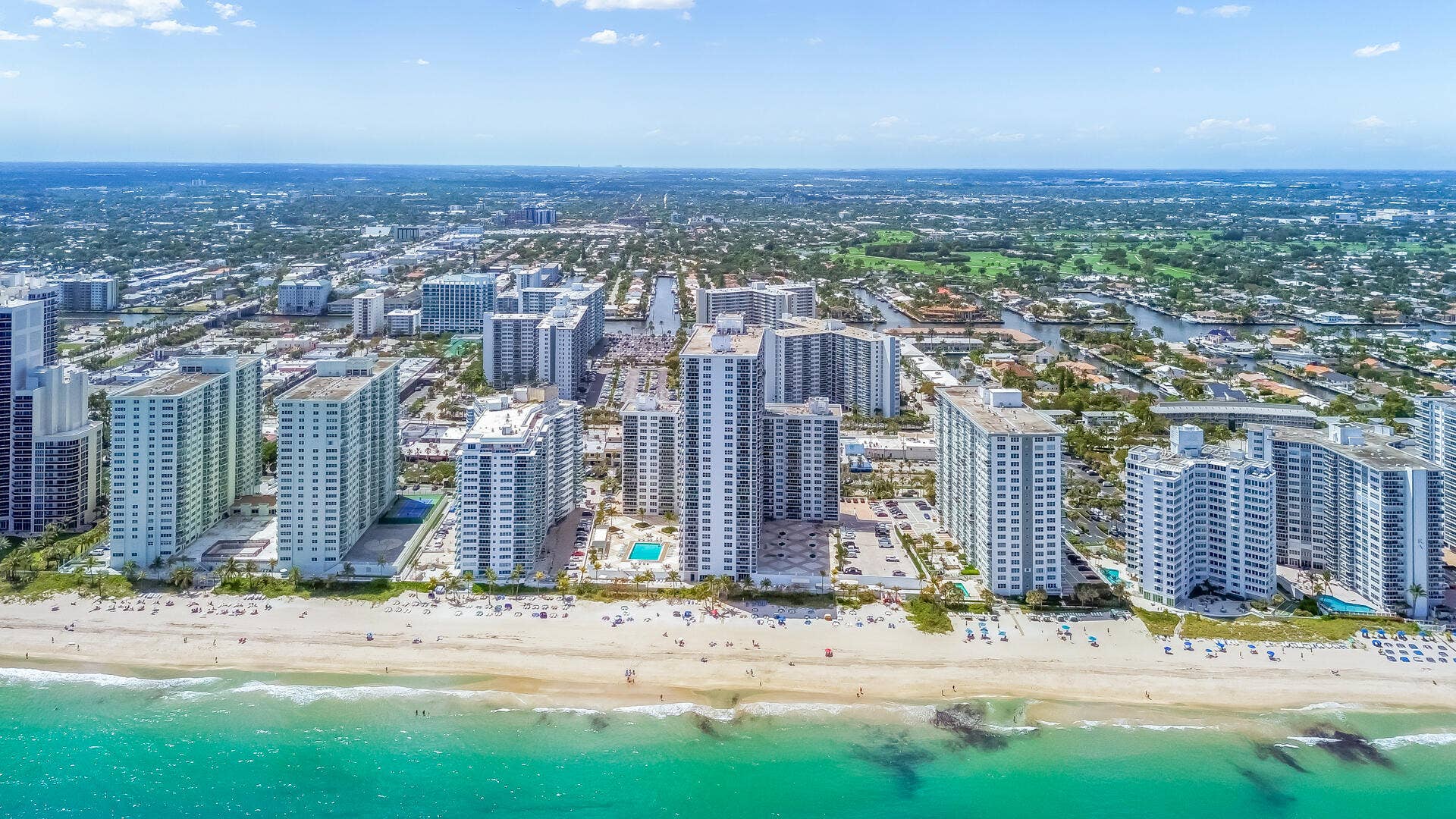 Expansive beach frontage with clear ocean water