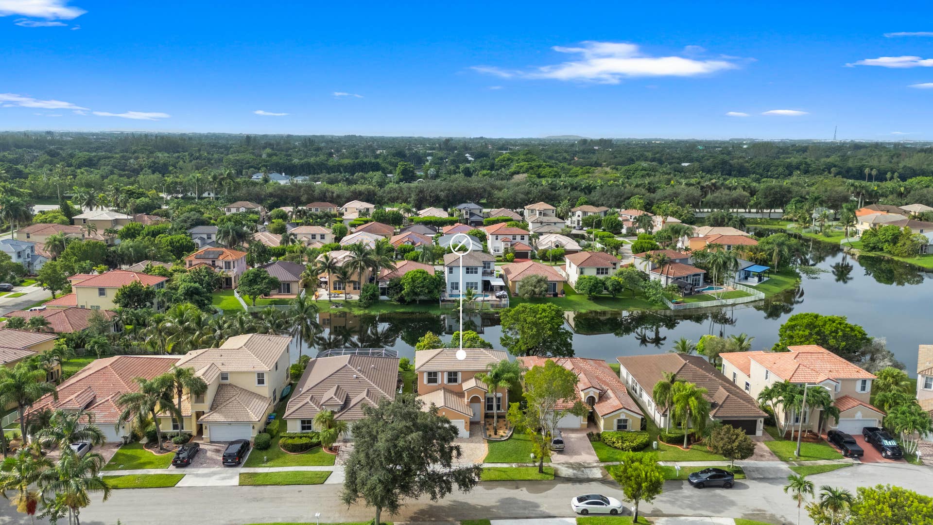 Elevated front view showing the homes residential setting with the lake directly behind the property.