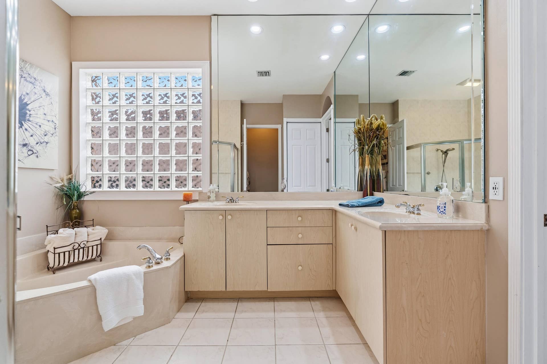 Dual-sink vanity, soaking tub and a separated shower and water closet complete the spacious primary bath.