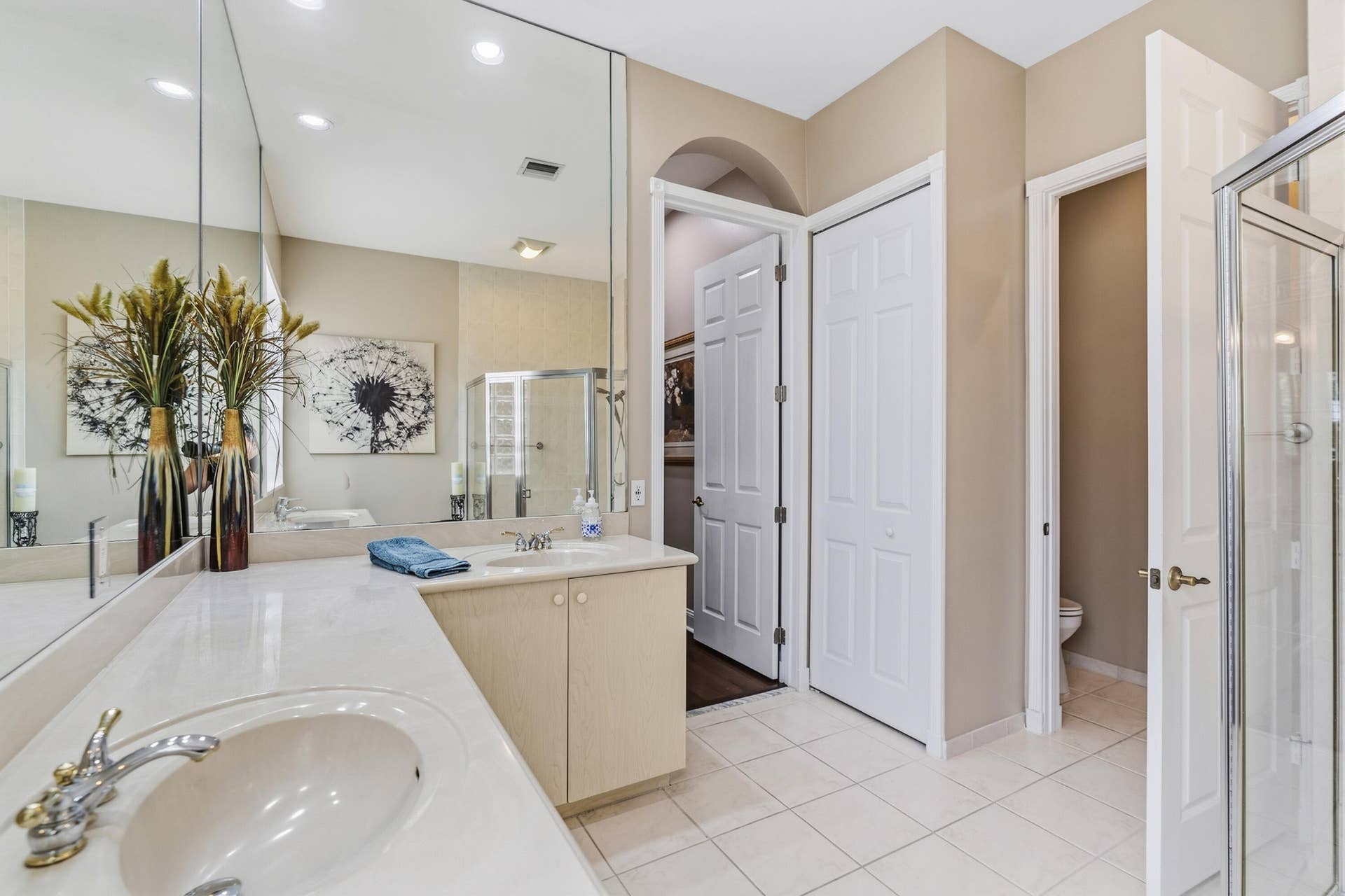 Extended vanity and generous counter space provide functionality and storage in the primary bath.