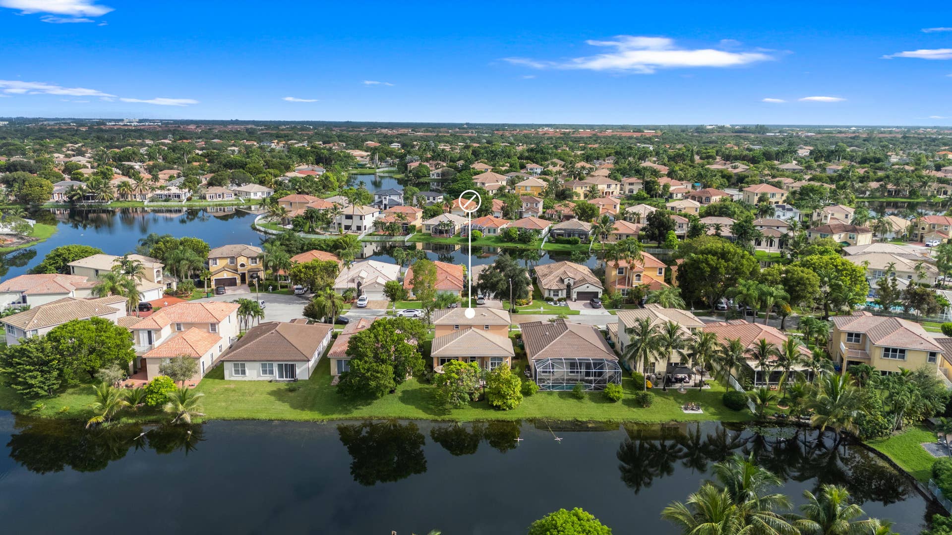 Elevated view highlighting the homes location among the interconnected lakes and surrounding residences of Monarch Lakes.
