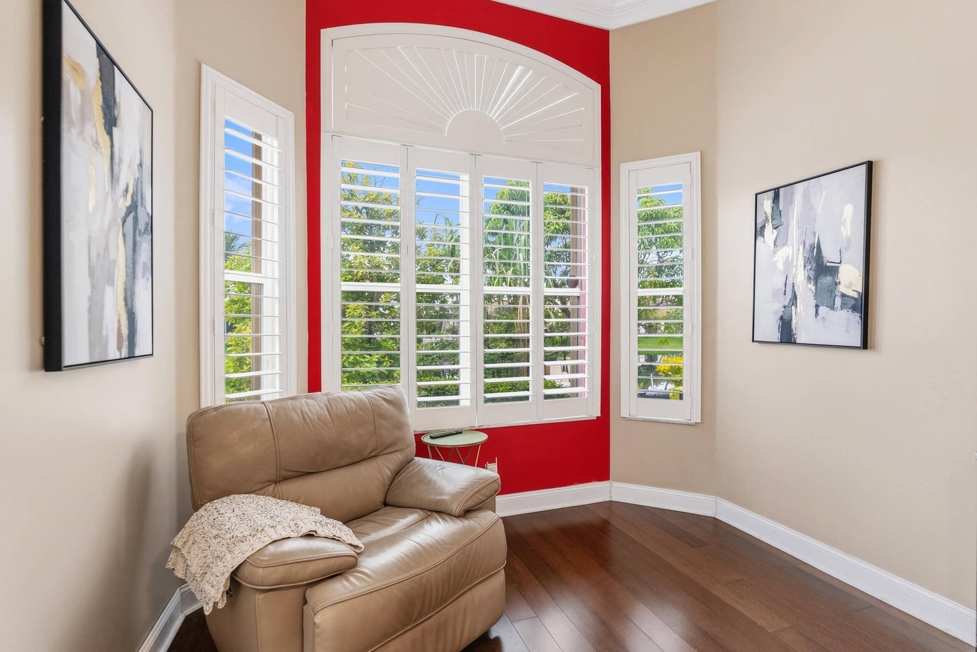 Dedicated seating area surrounded by windows creates a comfortable retreat within the primary suite.