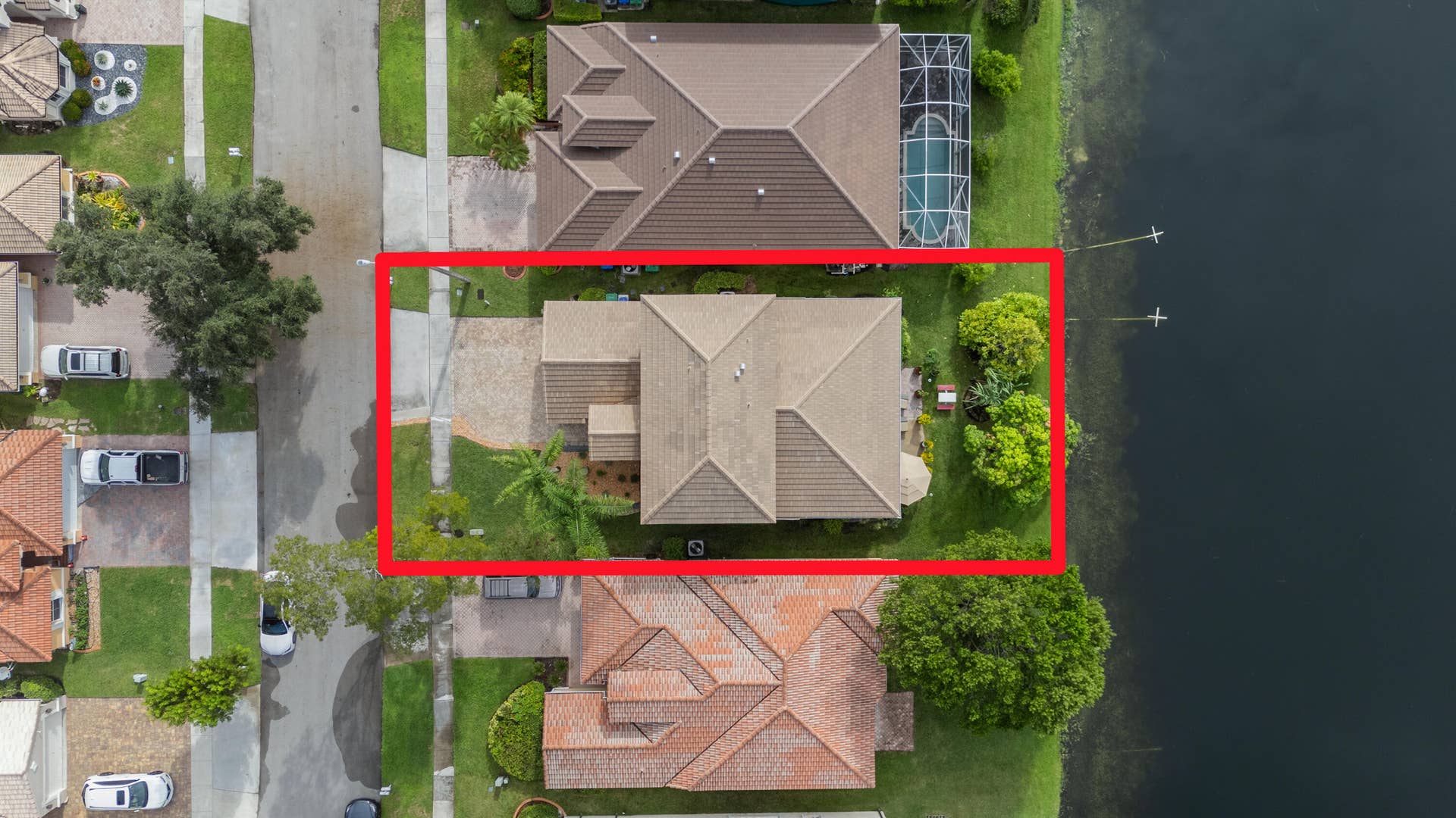 Overhead aerial highlighting the homes lakefront setting, backyard and position along the water.