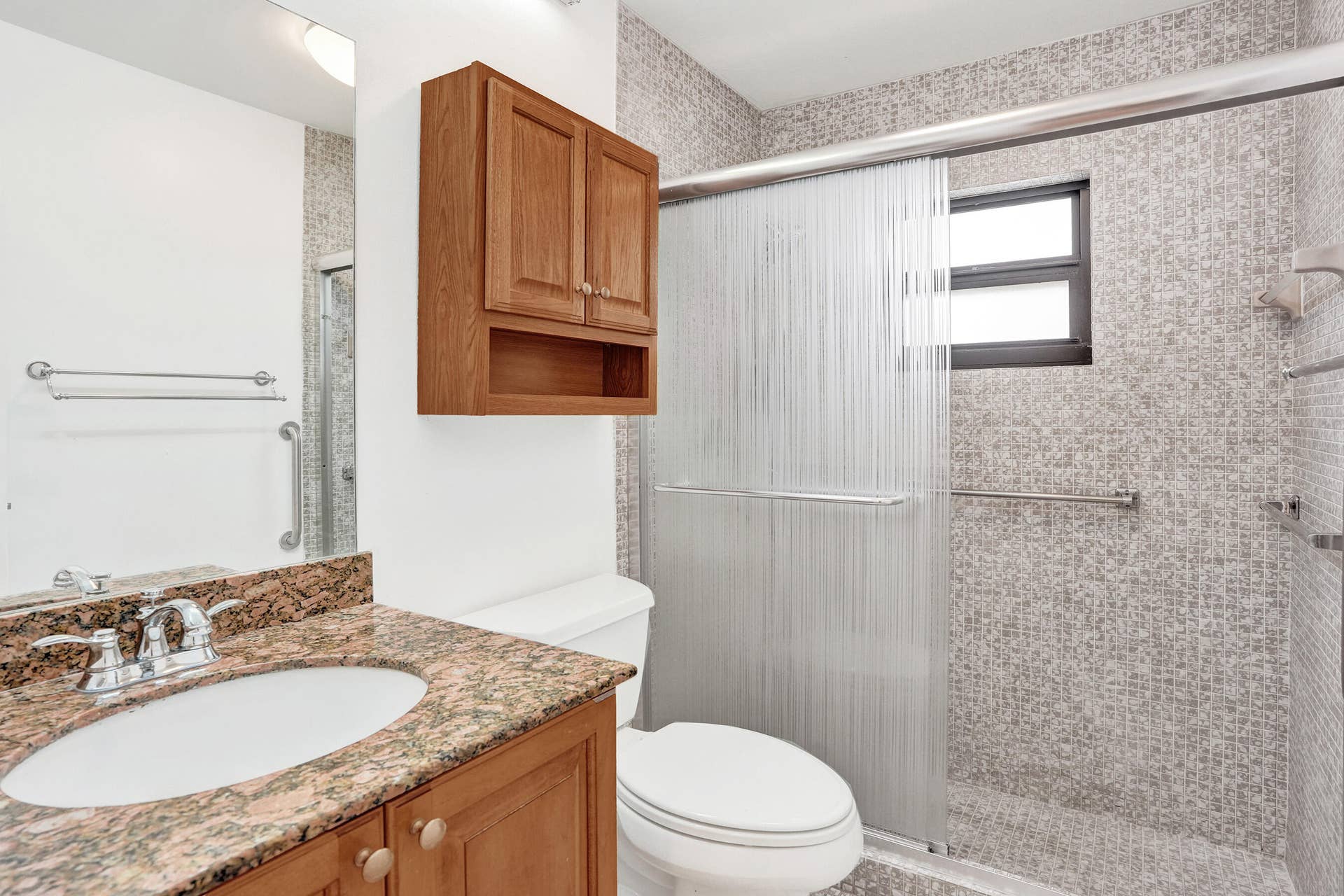 Vanity with a granite countertop and undermount sink