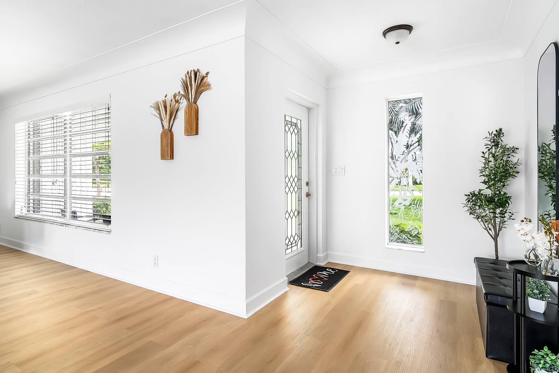 1250 SE 10TH Street, Deerfield Beach, Deerfield Beach, FL 33441 Entryway featuring a decorative glass panel door, light wood-finish flooring, a rectangular vertical window, crisp white walls, and crown molding