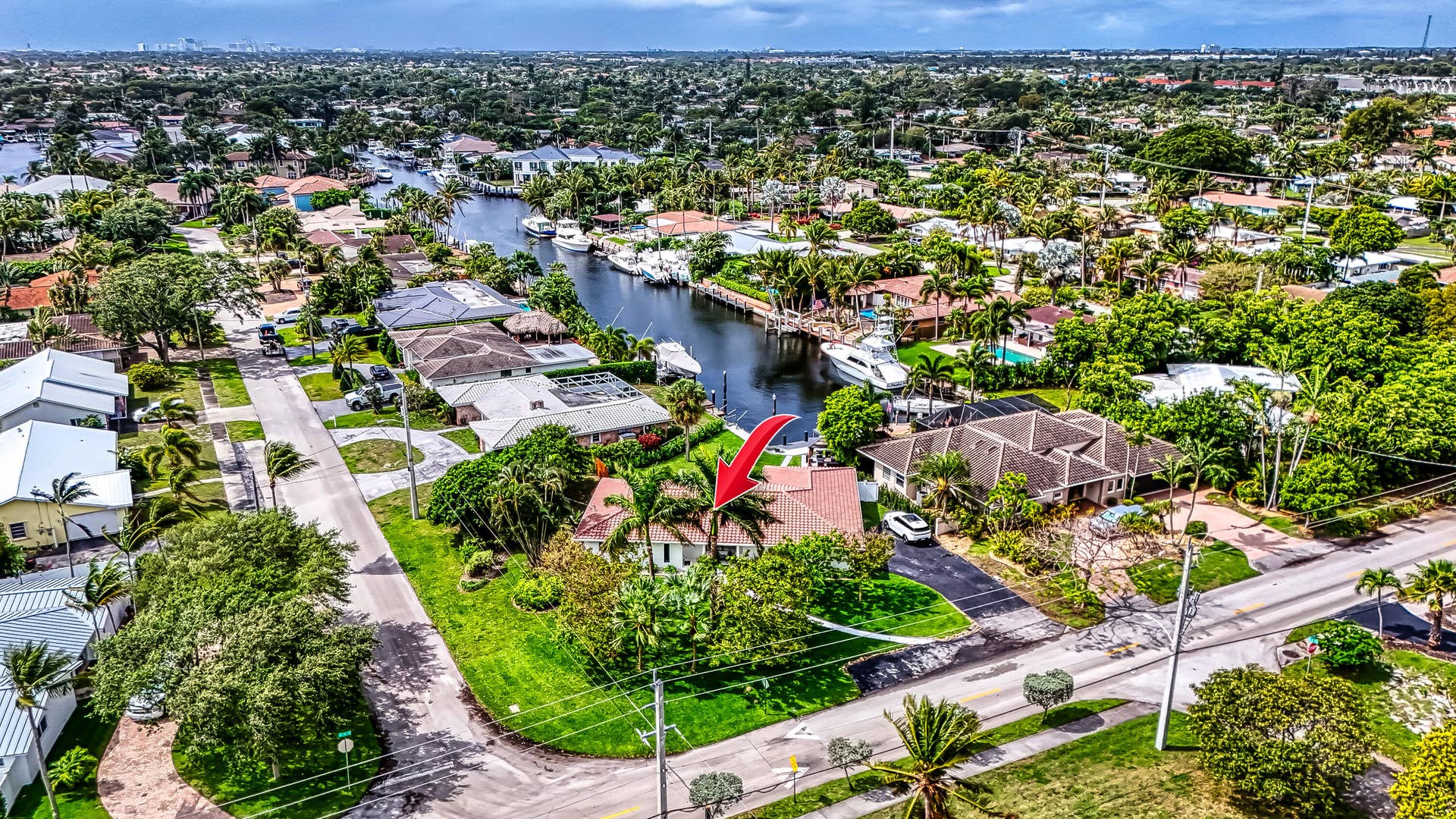1250 SE 10TH Street, Deerfield Beach, Deerfield Beach, FL 33441 Waterfront property featuring extensive landscaping, a private driveway, and mature tropical foliage