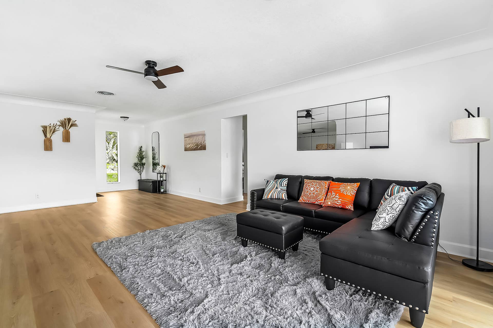 1250 SE 10TH Street, Deerfield Beach, Deerfield Beach, FL 33441 Expansive living area featuring light wood-finish flooring, white walls, and crown molding