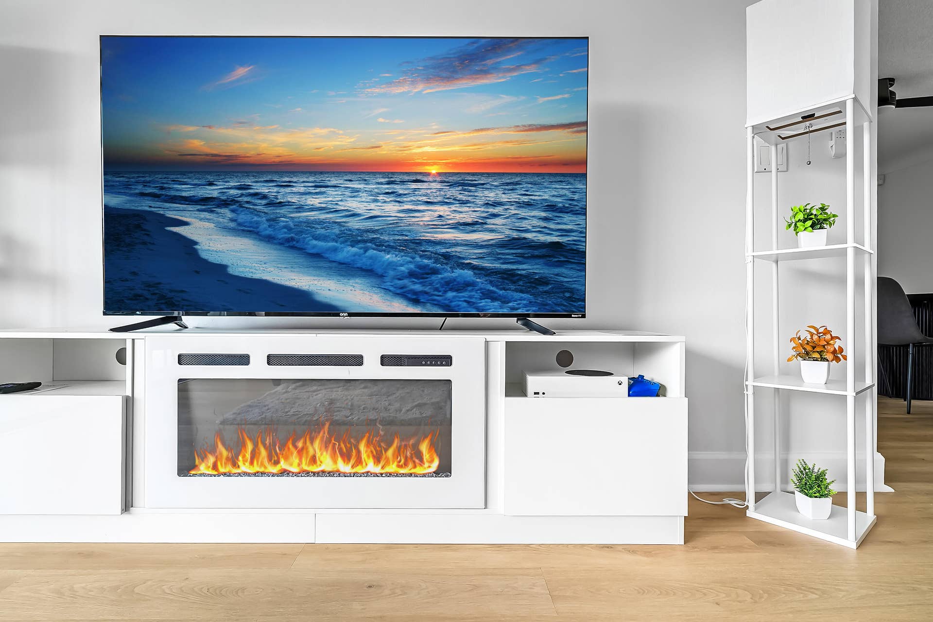 1250 SE 10TH Street, Deerfield Beach, Deerfield Beach, FL 33441 Contemporary media console with an integrated electric fireplace, featuring white cabinetry and light wood-finish flooring