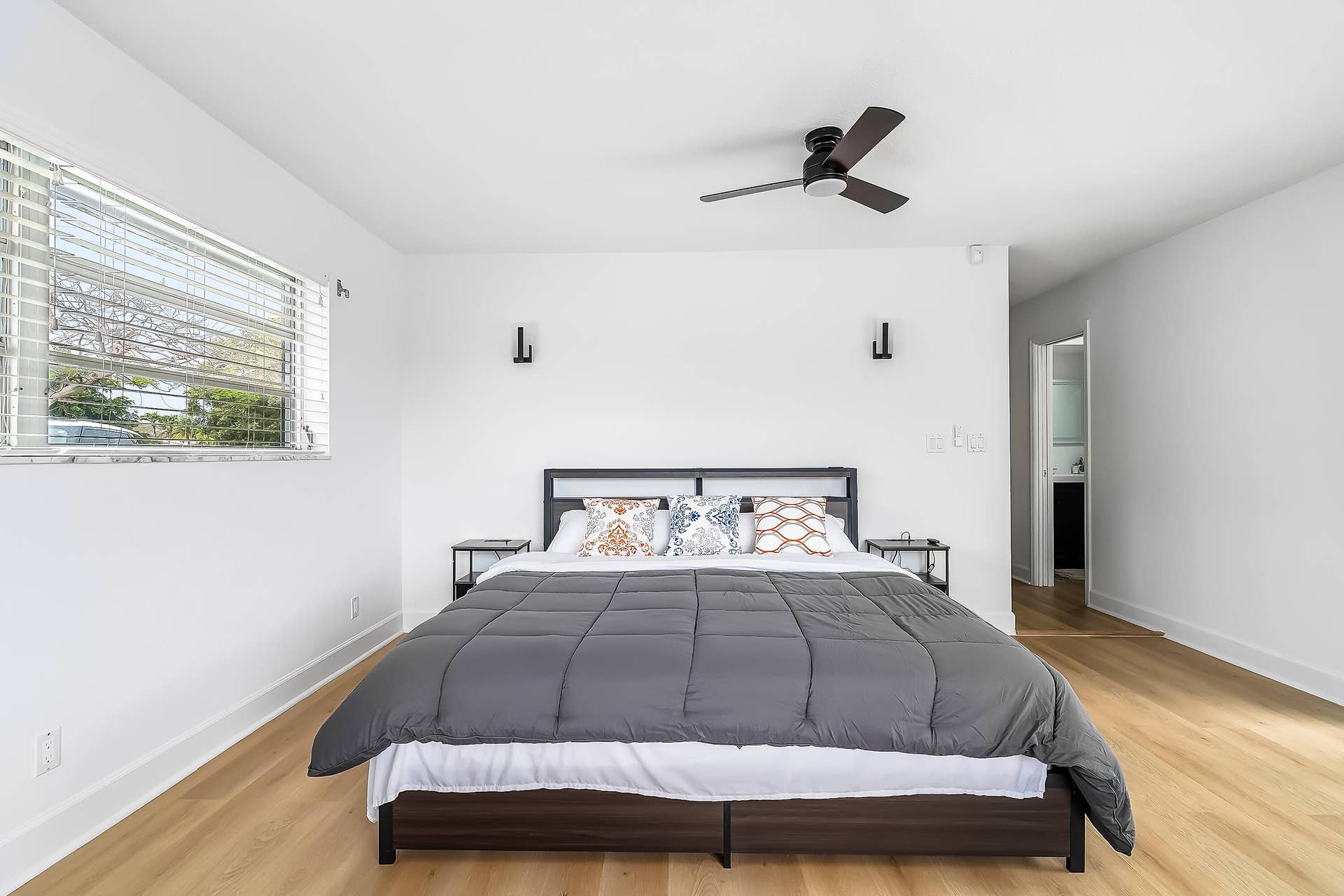 1250 SE 10TH Street, Deerfield Beach, Deerfield Beach, FL 33441 Bedroom featuring light wood-finish flooring, white walls, and a window with horizontal blinds