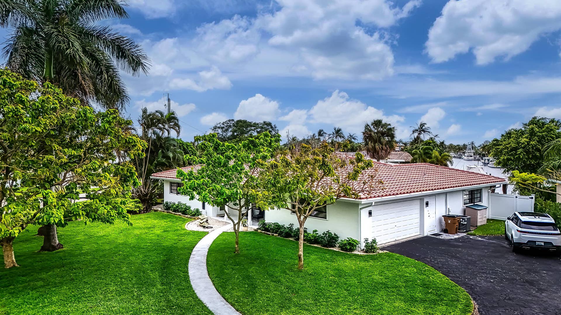 1250 SE 10TH Street, Deerfield Beach, Deerfield Beach, FL 33441 Exterior featuring a terracotta tile roof, white garage door, and a curved paved walkway