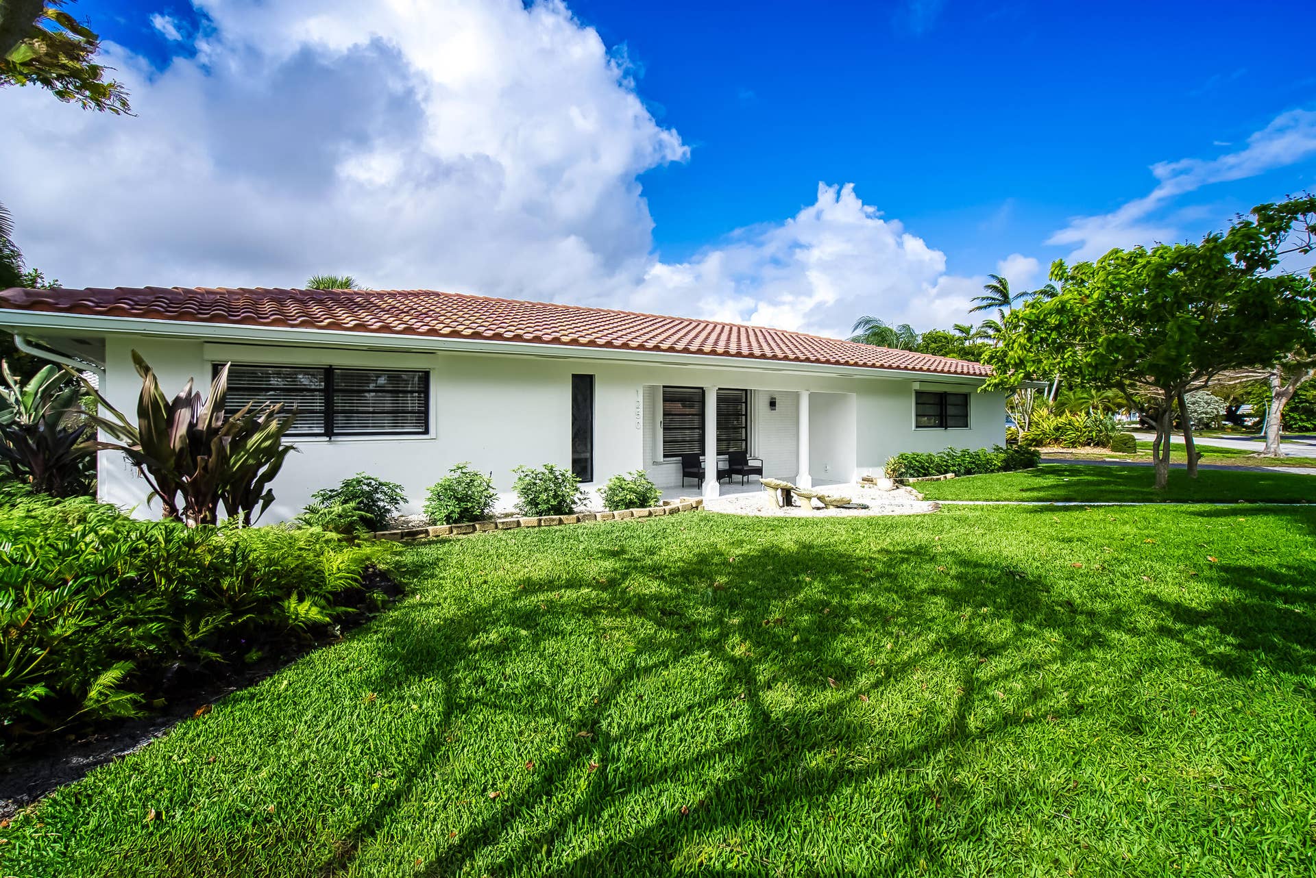 1250 SE 10TH Street, Deerfield Beach, Deerfield Beach, FL 33441 Single-story home featuring a terracotta tile roof, white stucco exterior, and black-framed windows