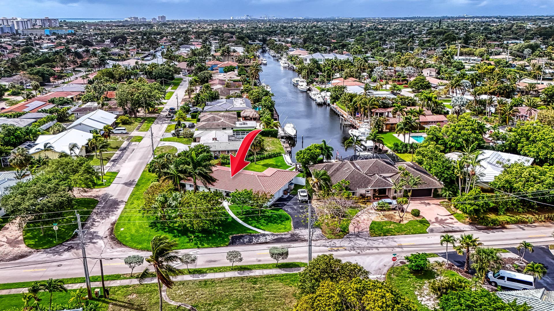 1250 SE 10TH Street, Deerfield Beach, Deerfield Beach, FL 33441 Waterfront property featuring a private boat dock, lush landscaping, and mature palm trees
