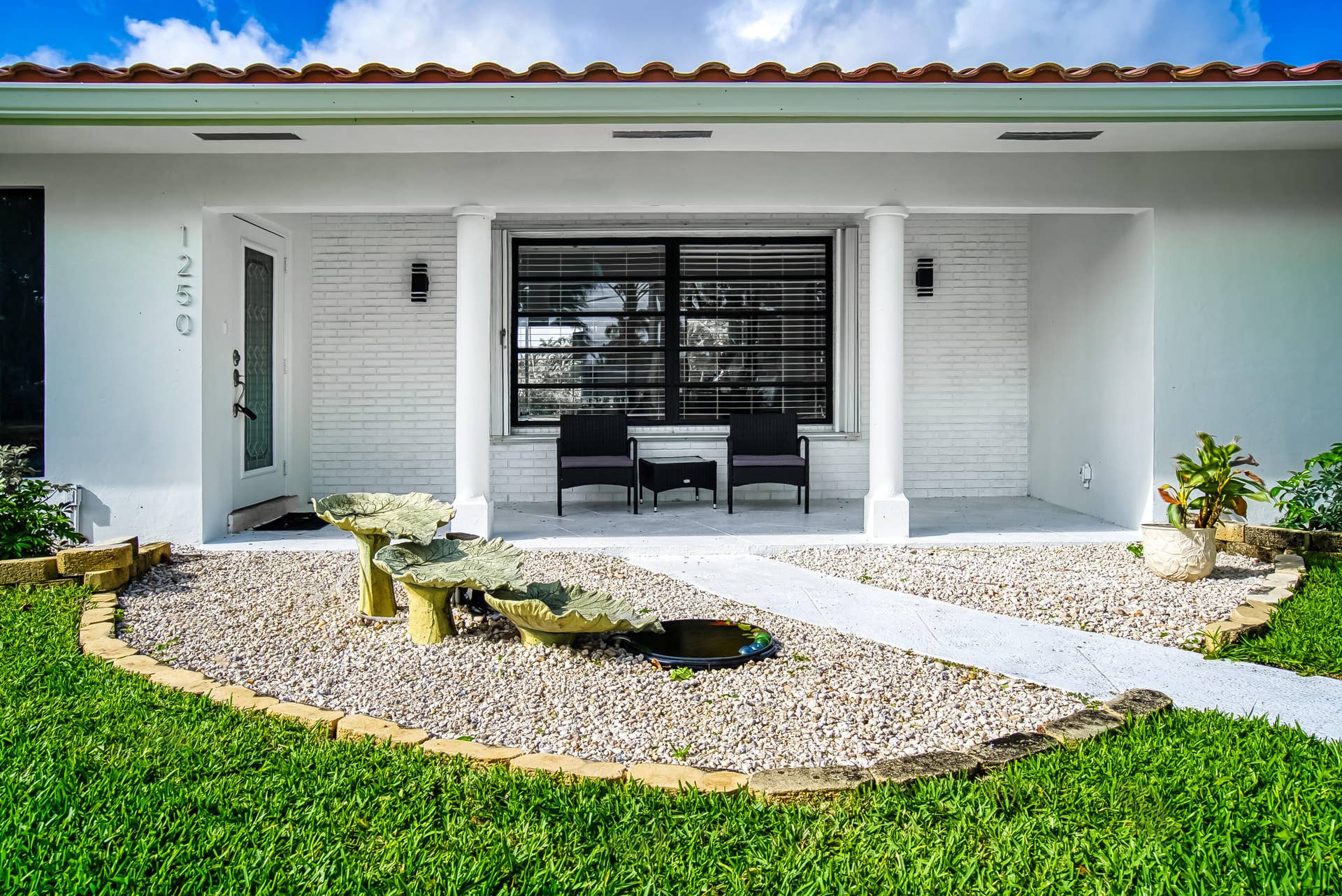 1250 SE 10TH Street, Deerfield Beach, Deerfield Beach, FL 33441 Front facade with a covered entry, white brick accents, and a tile roof