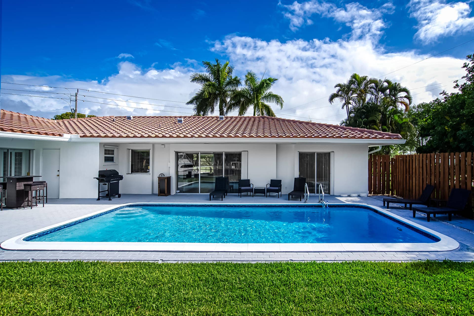 1250 SE 10TH Street, Deerfield Beach, Deerfield Beach, FL 33441 Rectangular swimming pool with a surrounding paved deck