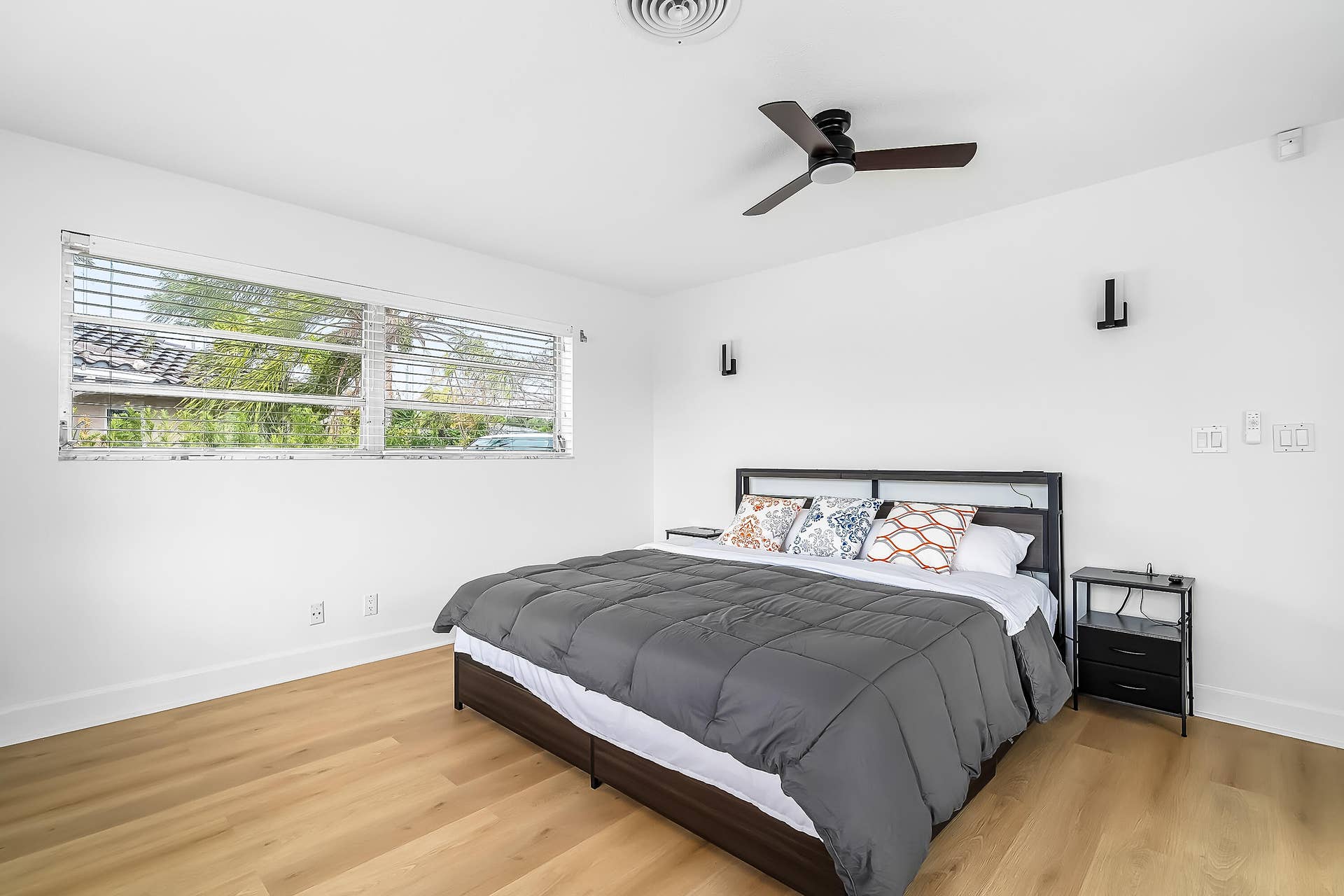 1250 SE 10TH Street, Deerfield Beach, Deerfield Beach, FL 33441 Bedroom featuring wood-finish flooring, a ceiling fan, and two wall-mounted light fixtures